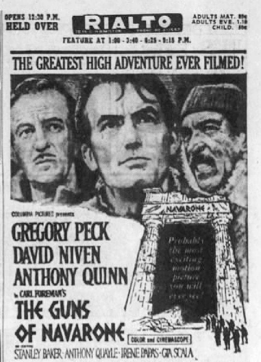 Vintage black and white movie poster for 'The Guns of Navarone,' featuring illustrated portraits of three actors above a stone archway.