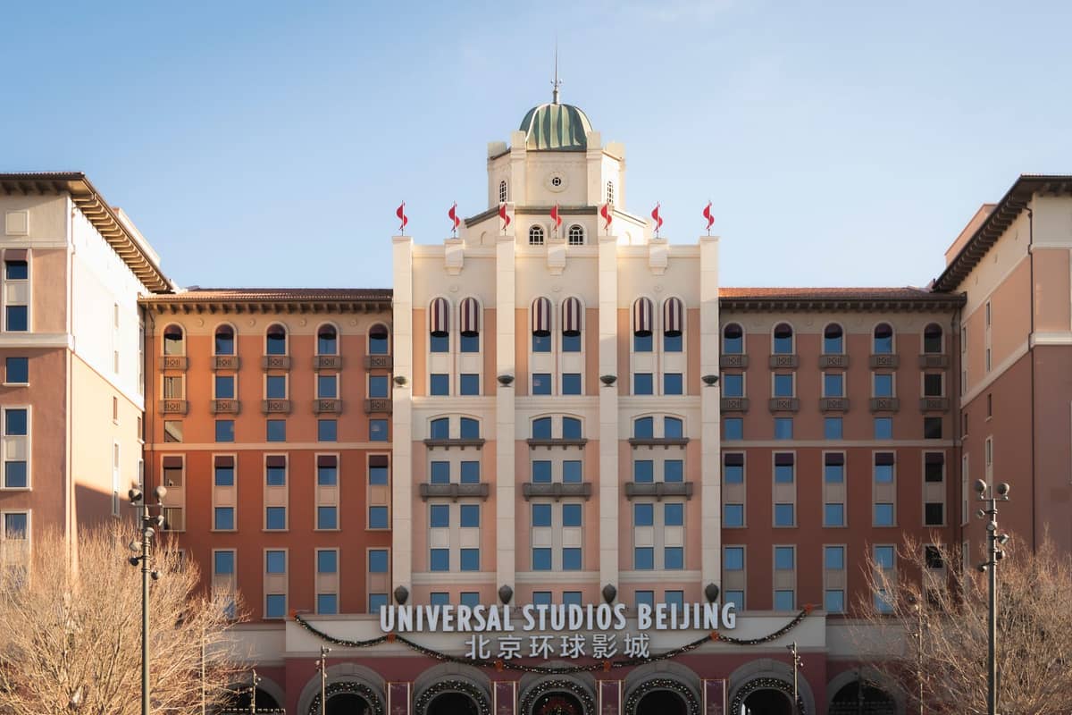 The entrance to Universal Studios Beijing, showing the main hotel facade with the theme park’s Chinese and English signage clearly visible.