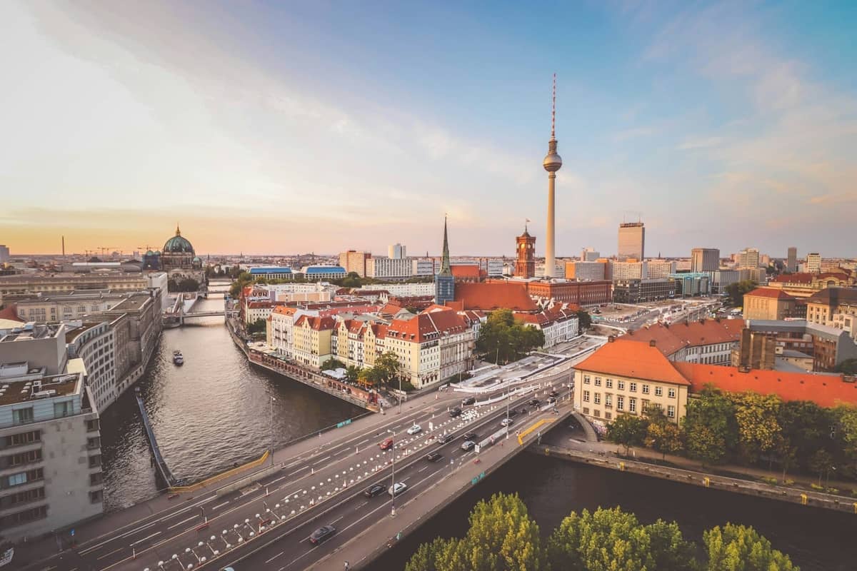 Pemandangan udara yang cerah di pusat kota Berlin dengan menara TV, sungai Spree, dan bangunan bersejarah di bawah langit musim panas yang cerah.