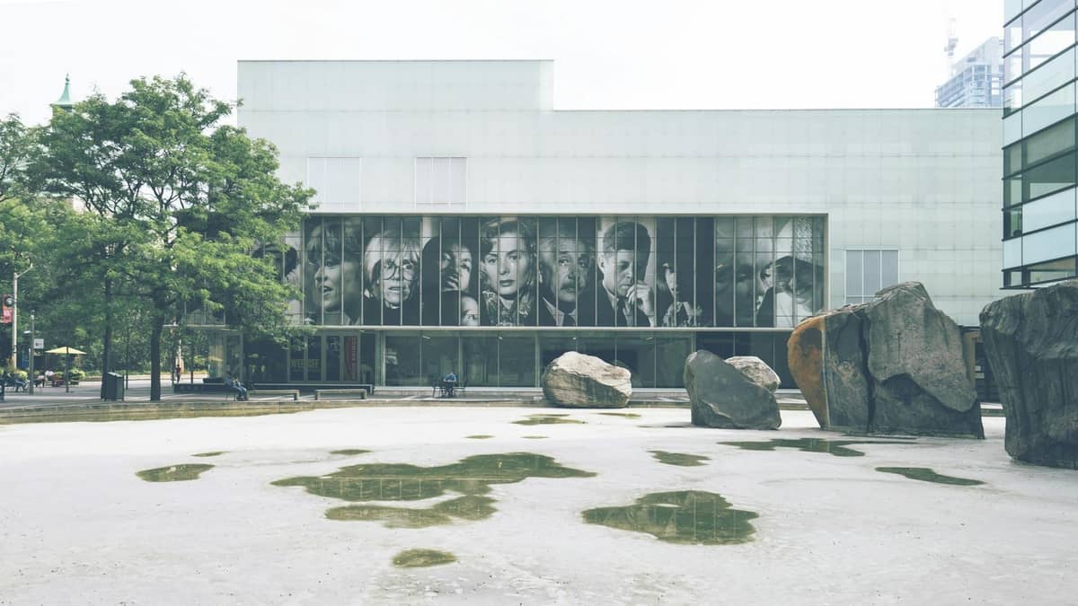 Edificio del museo d'arte moderna a Chicago con grandi ritratti nelle finestre e massi nella piazza delle sculture sul davanti.