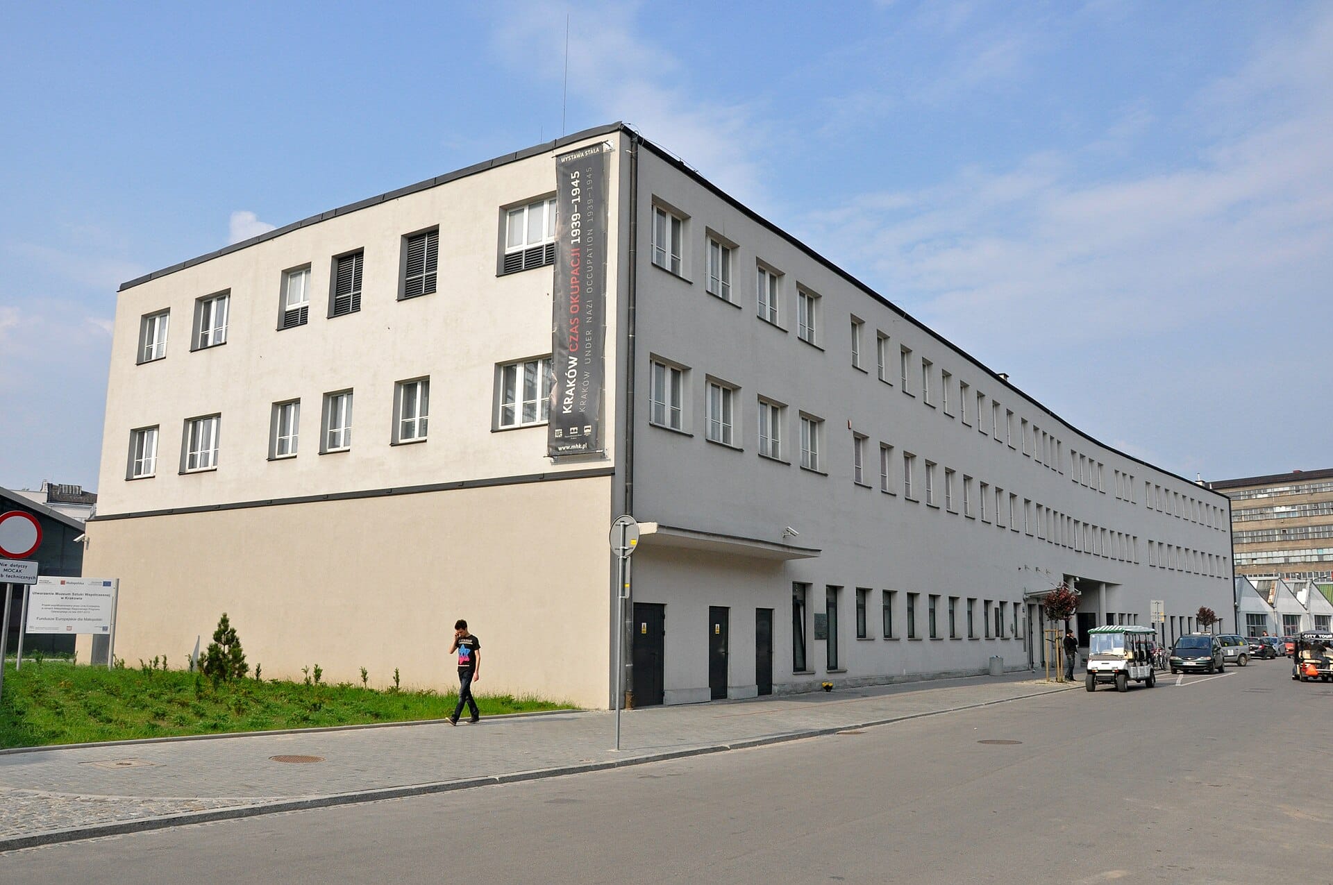 วิวภายนอกของพิพิธภัณฑ์โรงงานเคลือบของ Oskar Schindler ใน Kraków สถานที่ทางประวัติศาสตร์สำคัญในสงครามโลกครั้งที่สองที่มีส่วนหน้าอาคารสีครีมทันสมัย