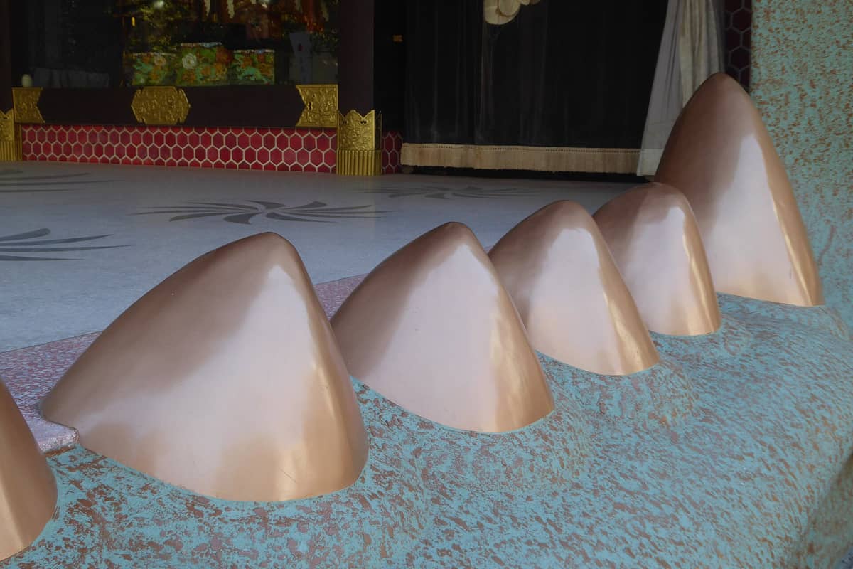 Close-up of the giant fangs at the entrance of Namba Yasaka Shrine's distinctive lion head stage in Osaka.