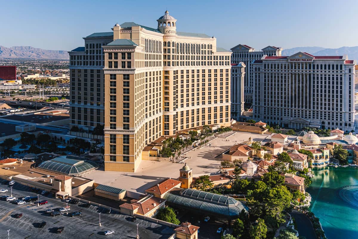 Aerial view of Bellagio Hotel and surrounding Las Vegas Strip landmarks in bright, clear spring daylight with minimal crowds and blue skies.