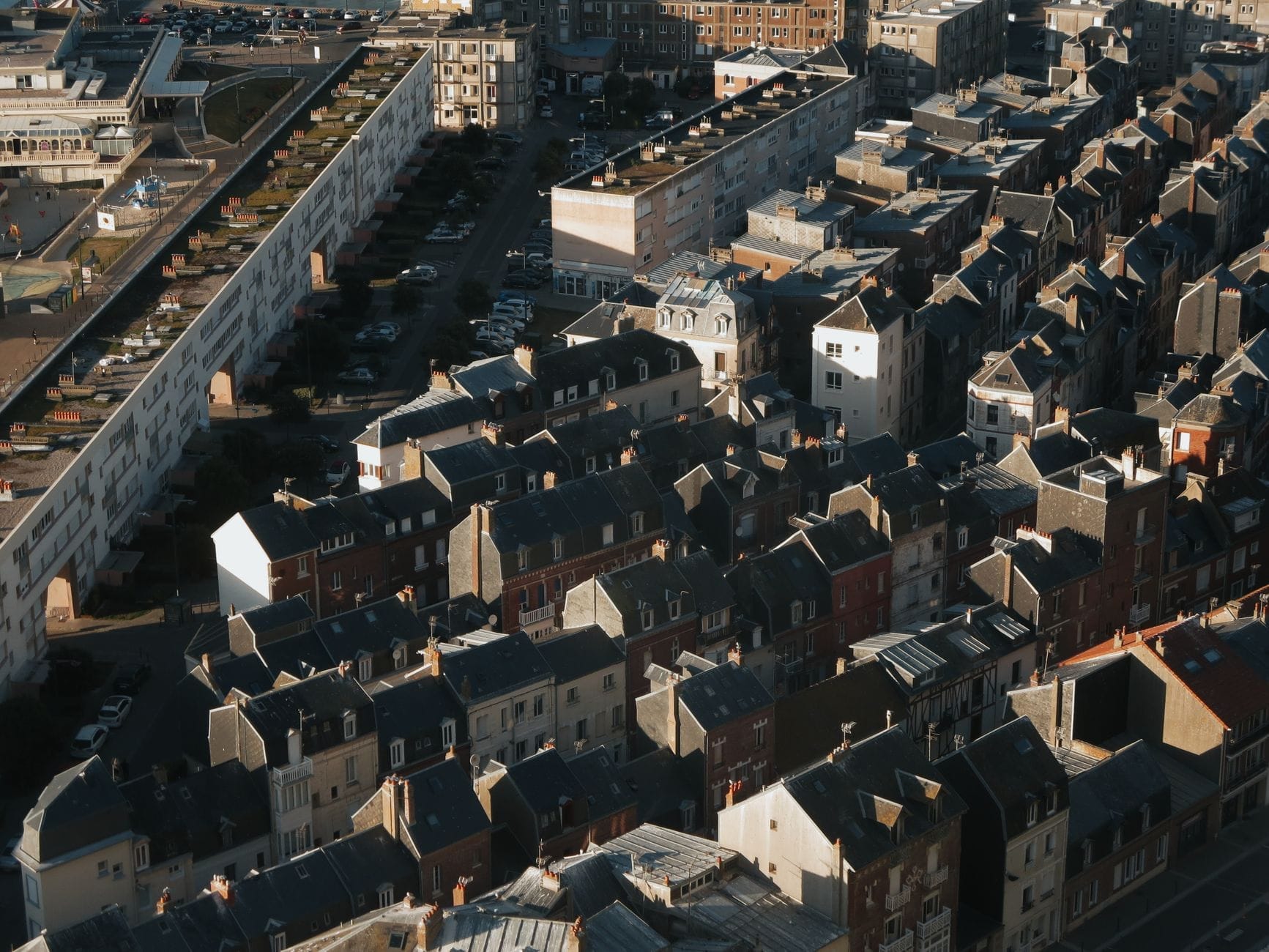 Aerial view of Le Havre’s city center with distinctive postwar buildings under soft daylight, capturing urban atmosphere in spring.
