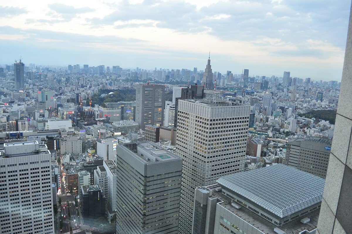 Elevated view over Shinjuku with Tokyo landmarks and skyscrapers, as seen from a free observation deck in the Metropolitan Government Building.