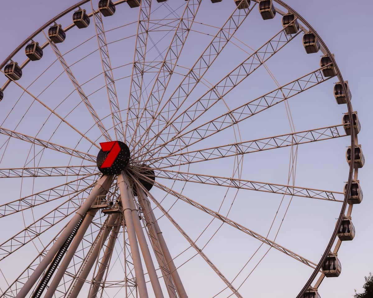 Gran noria, la Wheel of Brisbane, contra un cielo despejado al atardecer, destacando una memorable experiencia familiar.