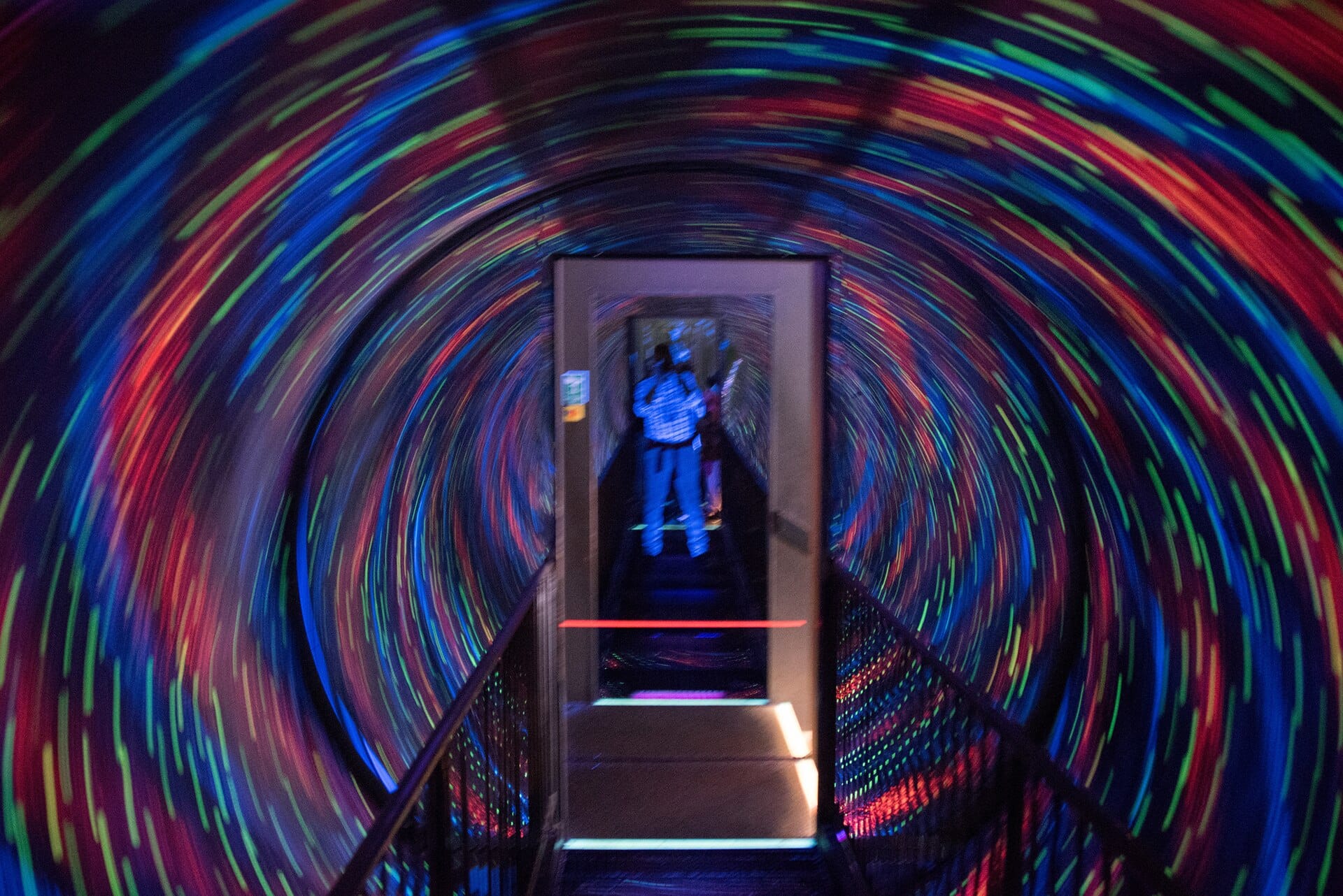 Ein bunter, sich drehender Vortex-Tunnel in der Camera Obscura & World of Illusions in Edinburgh – ein Laufweg durch einen rotierenden Tunnel mit leuchtenden Lichtmustern.