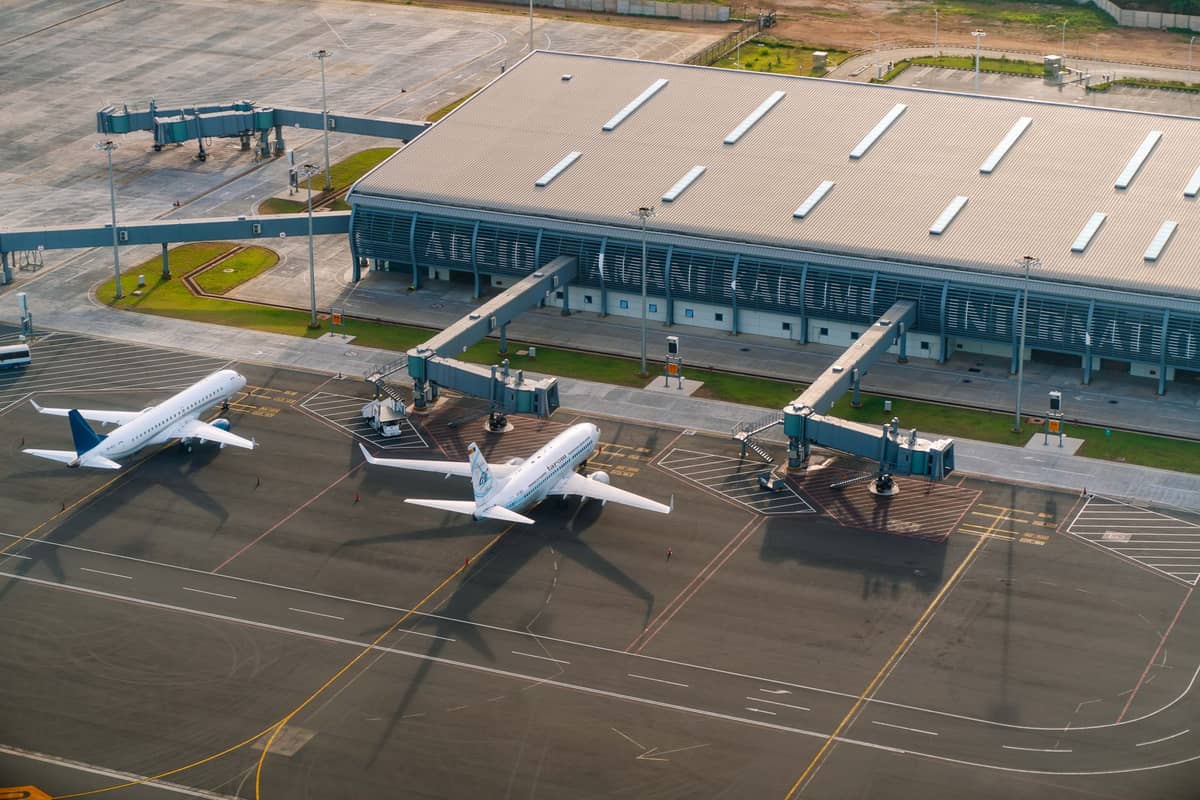 Aerial view of Rafael Núñez International Airport terminal with three planes at boarding gates in Cartagena, Colombia.