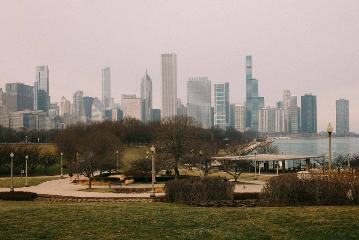 Wide view of Grant Park with Chicago skyline in the background, pathways, trees, and city park infrastructure clearly visible.
