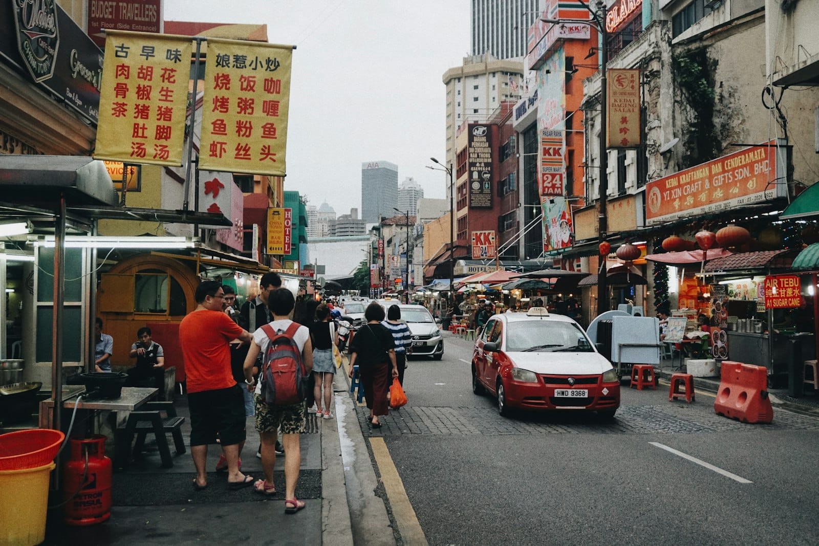 Chinatown Kuala Lumpur street with food stalls, Chinese signage and busy market scene on Petaling Street
