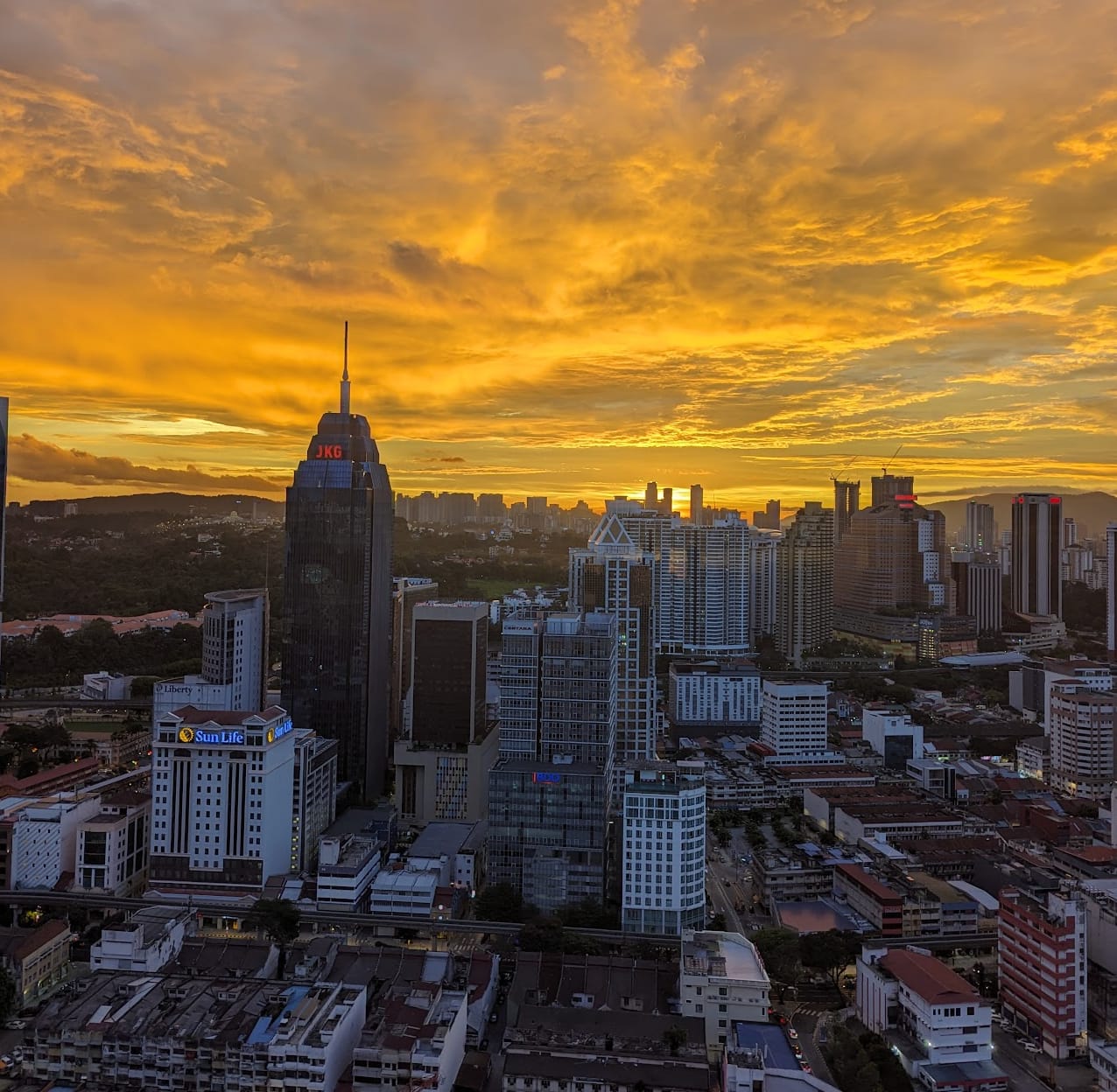 Kuala Lumpur skyline at sunset with JKG Tower and Chow Kit district in golden light