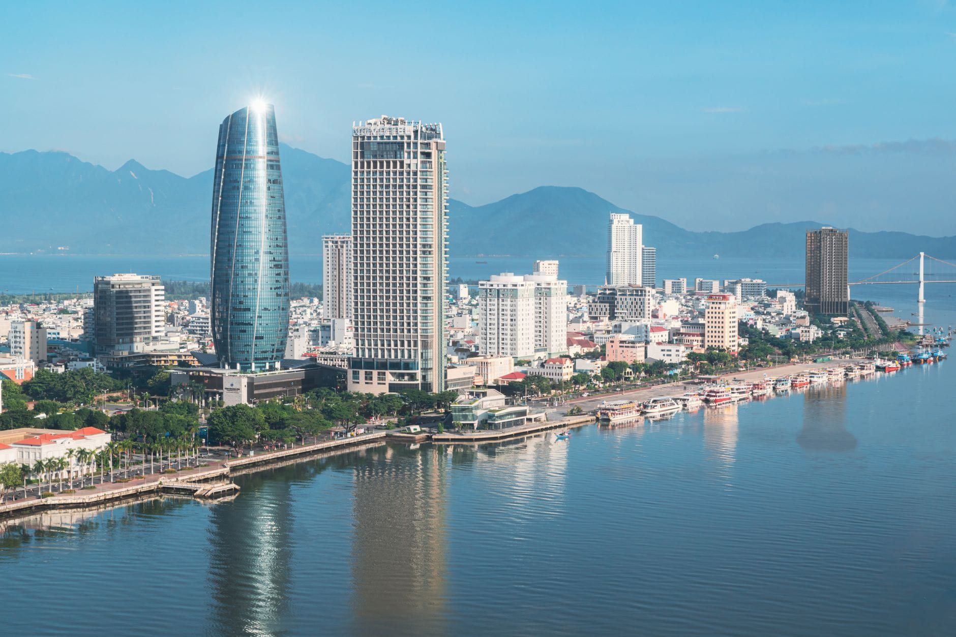 Skyline of Da Nang city with high-rise buildings, the Han River, and mountain backdrop on a clear day, showing the most iconic and recognizable view of Da Nang.
