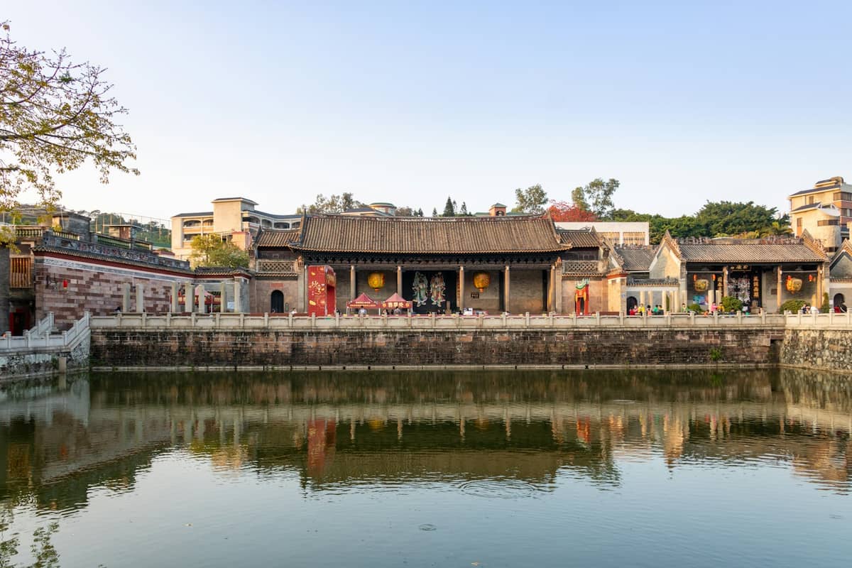 Historic ancestral temple with traditional architecture reflected in a calm pond, representing Foshan as a top day trip destination from Guangzhou.