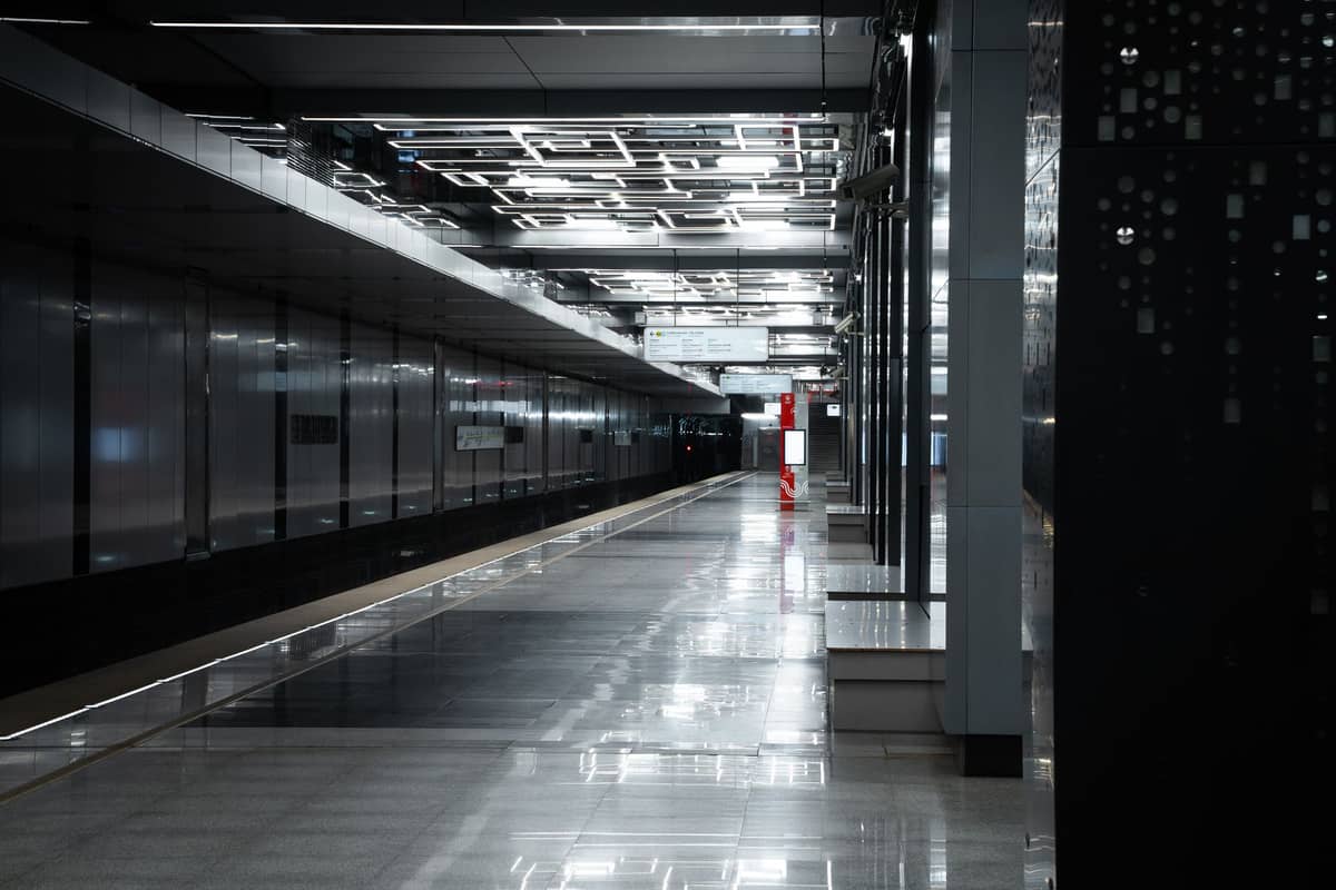 Moderne, gut beleuchtete U-Bahnstation mit schlankem Schwarz-Silber-Design und leerem Bahnsteig in Doha.