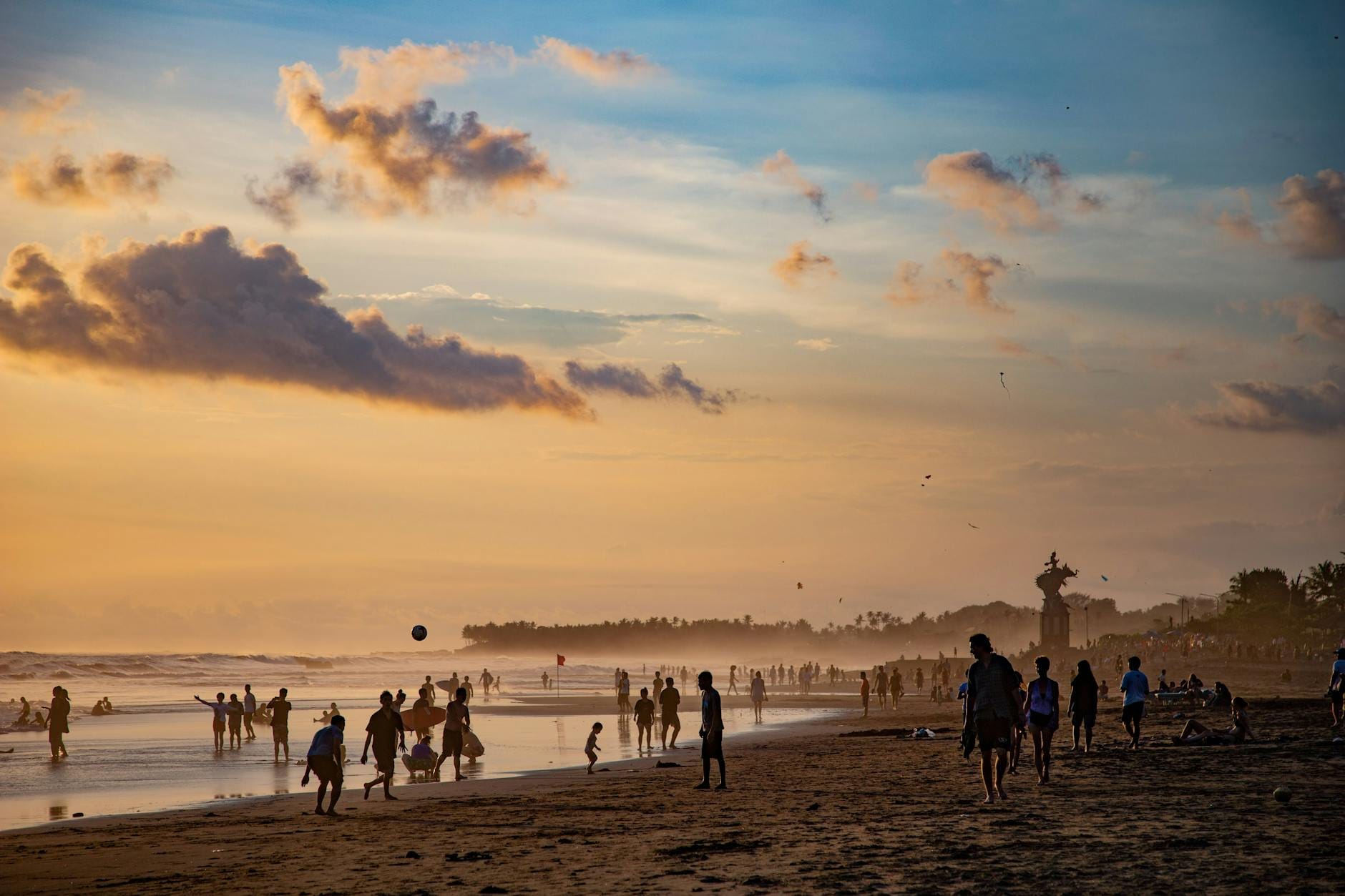 Scena serena del tramonto a Echo Beach con acque calme e riva di sabbia nera a Canggu, Bali