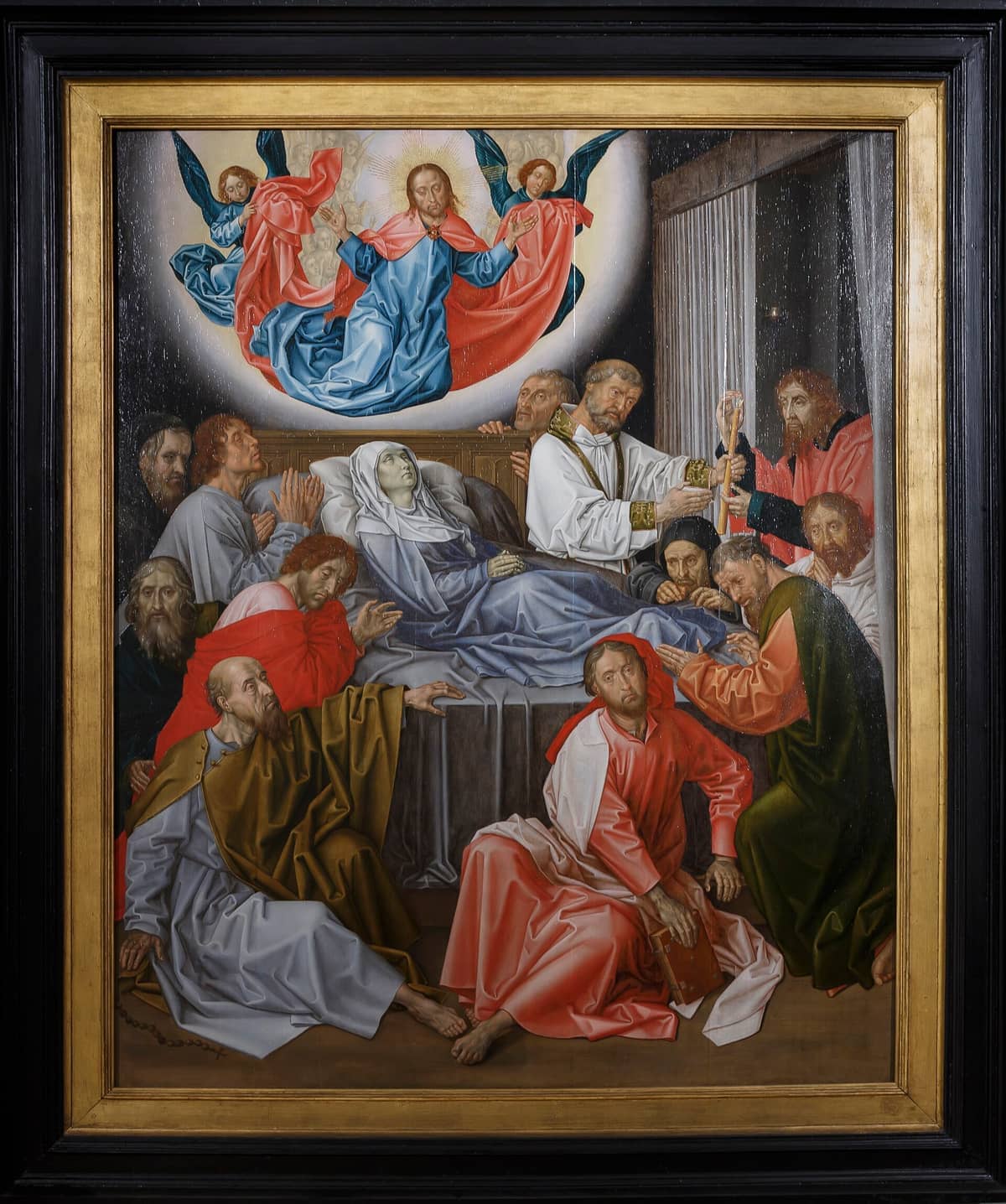 Detailed Flemish Primitive painting showing the Dormition of the Virgin, surrounded by apostles, on display at a Bruges art museum.