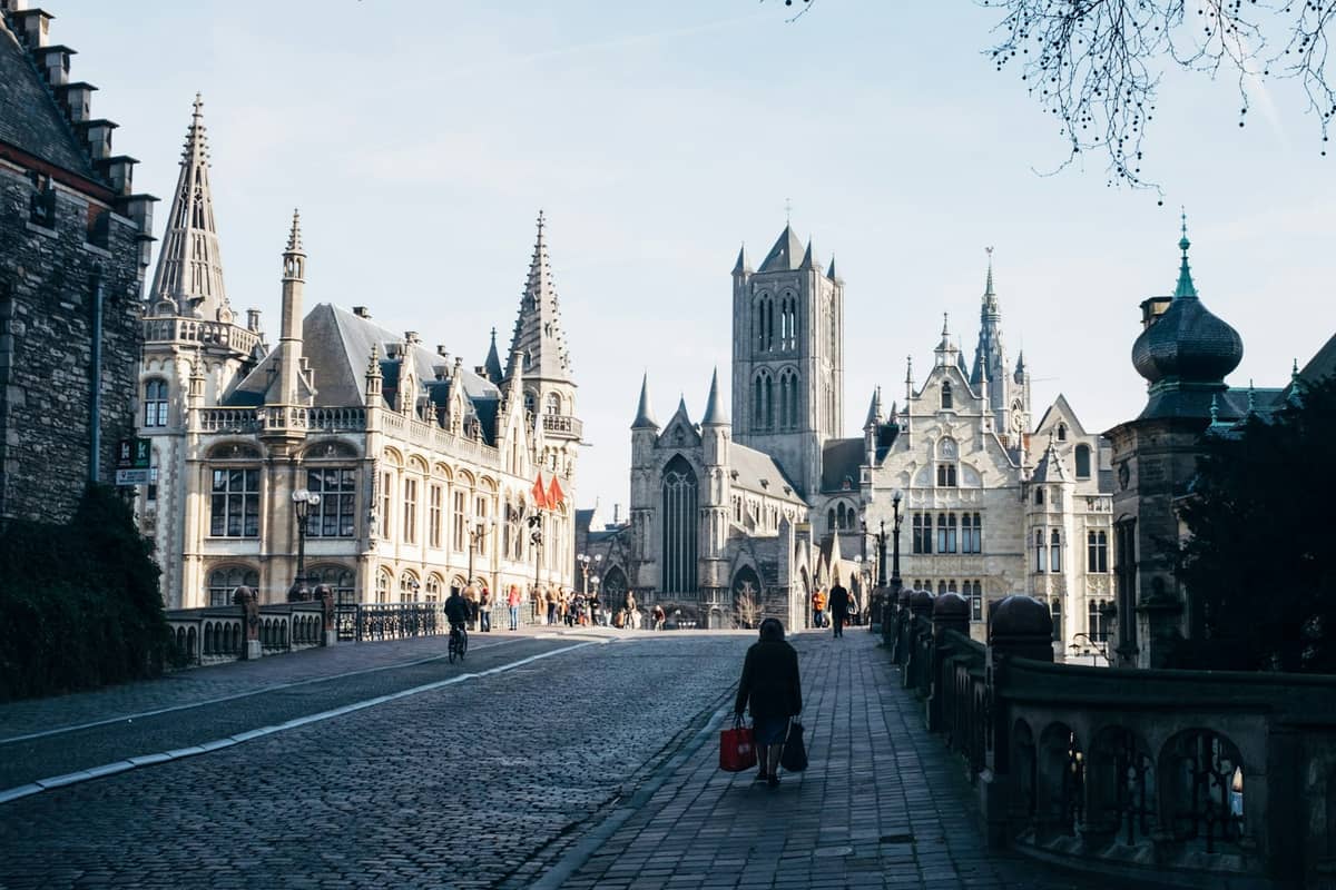 View from St. Michael’s Bridge in Ghent showing the towers of St. Bavo's Cathedral, Saint Nicholas' Church, and guildhalls central to Flemish master art.