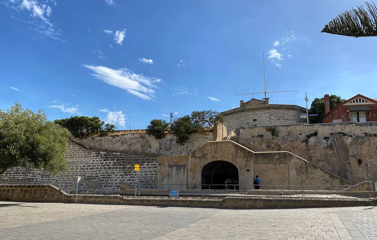 El Fremantle Round House, un histórico edificio de piedra caliza de estructura poligonal, se alza sobre Arthur Head con un cielo azul de fondo.