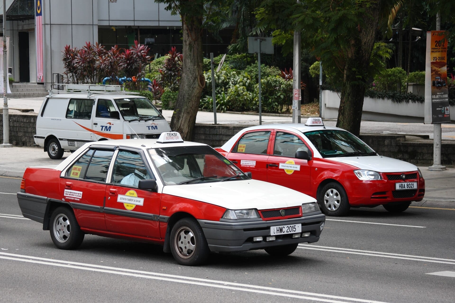 Kuala Lumpur metered taxis wait by the curb, ready to help travelers navigate the city’s busy downtown streets with ease.