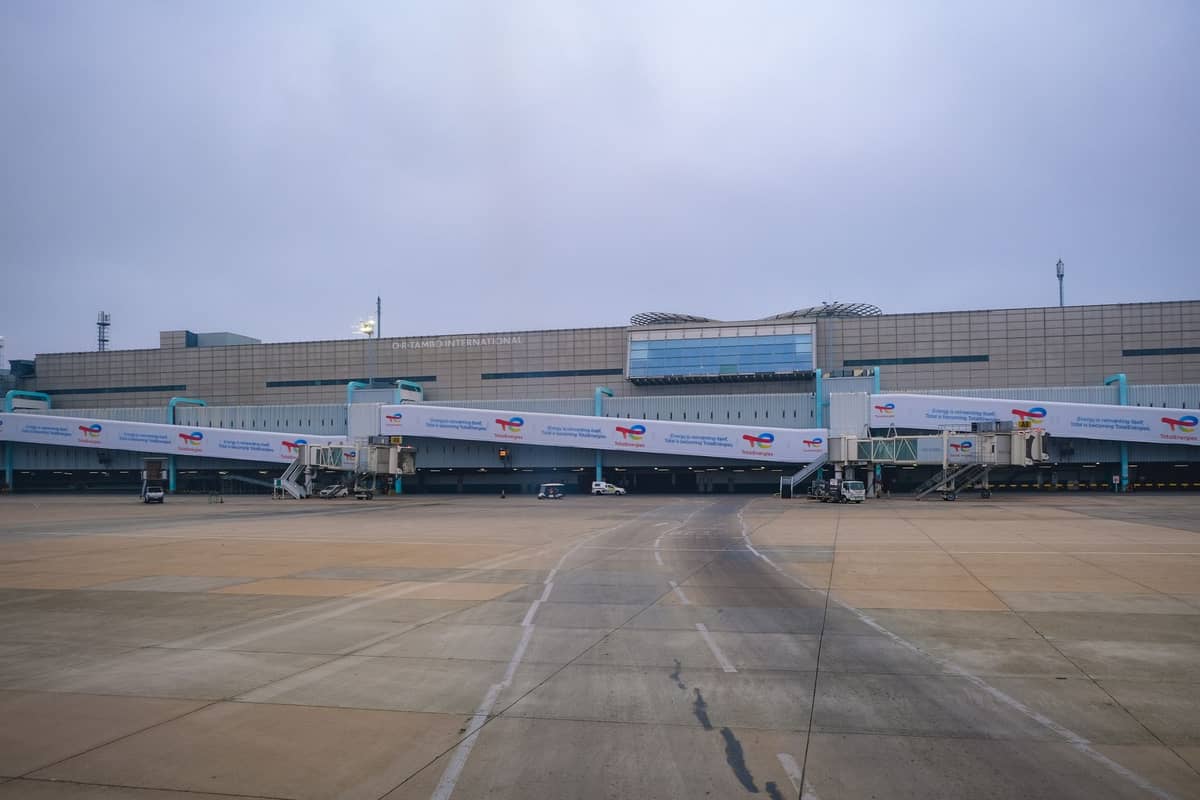 Wide view of Kansai International Airport terminal with multiple boarding bridges and overcast sky
