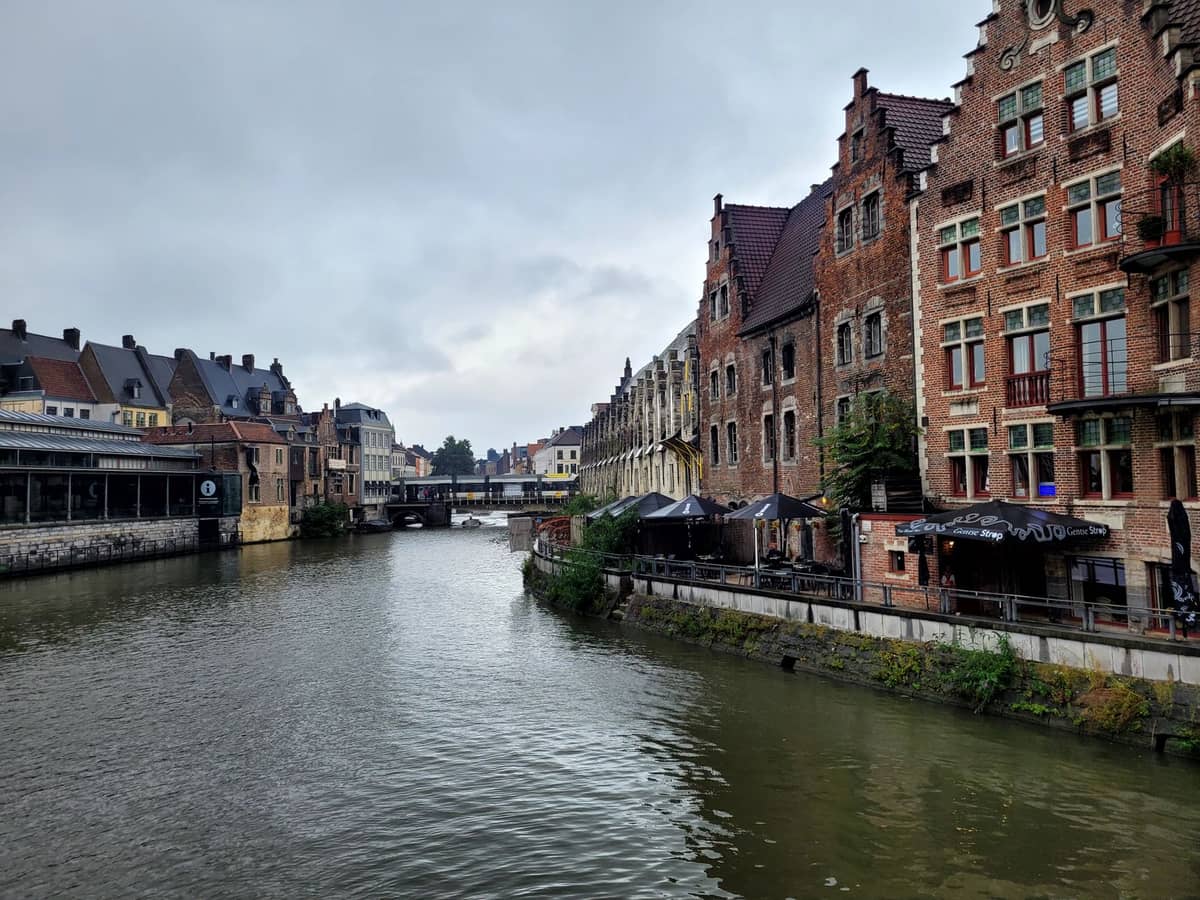 Outdoor canal-side cafés and bars in Ghent with student-friendly atmosphere on a cloudy day