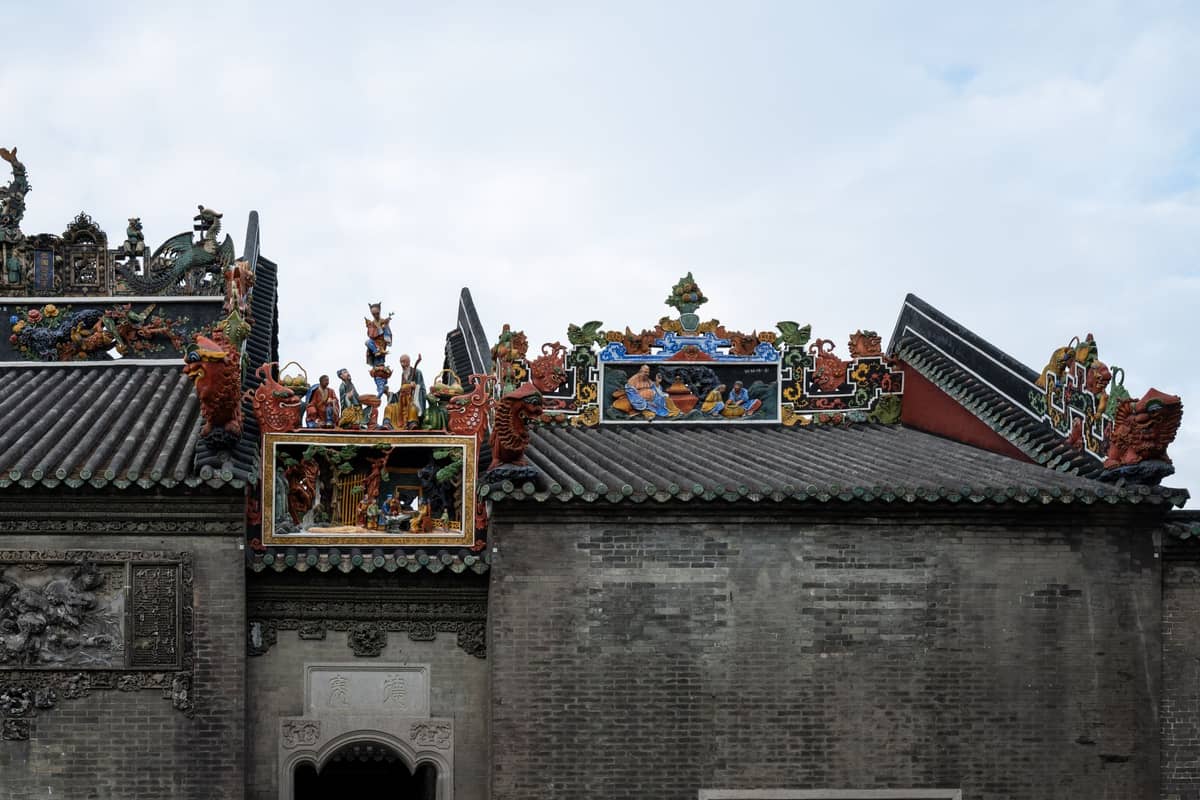 Roof of the Chen Clan Ancestral Hall in Guangzhou, decorated with colorful ceramic figurines and intricate carvings.