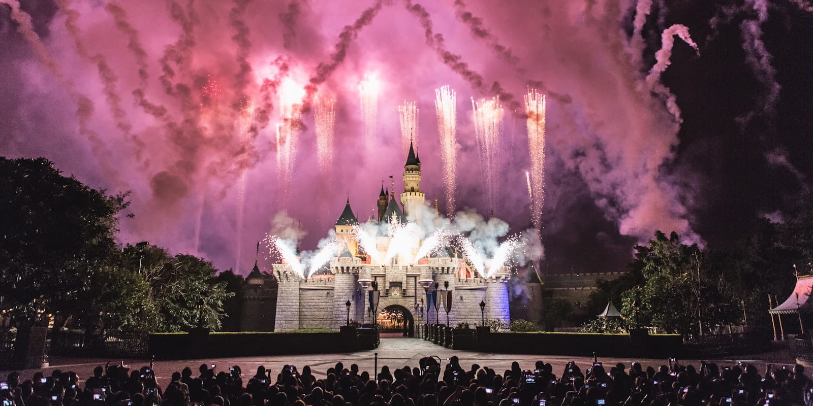 Scena incantata al crepuscolo all'Hong Kong Disneyland con il castello illuminato.