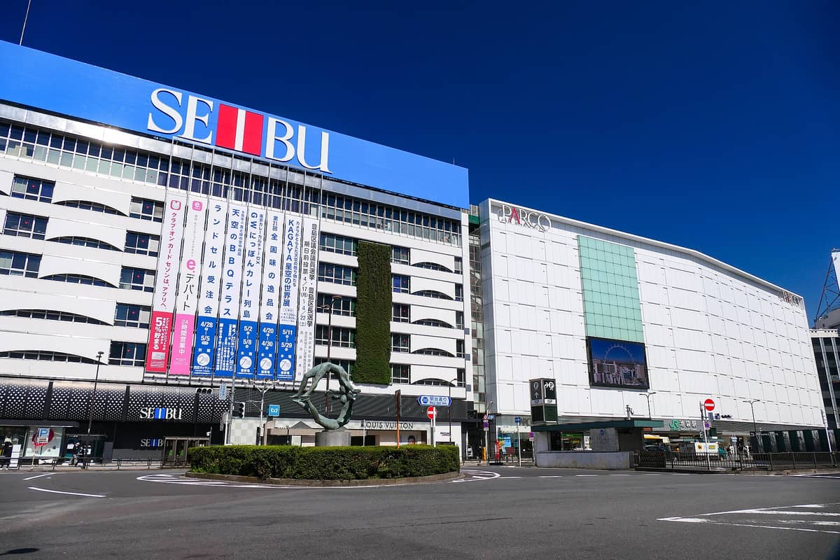 Ikebukuro’s iconic Seibu and Parco department store buildings on a sunny day, viewed from the plaza outside Ikebukuro Station in northwestern Tokyo.