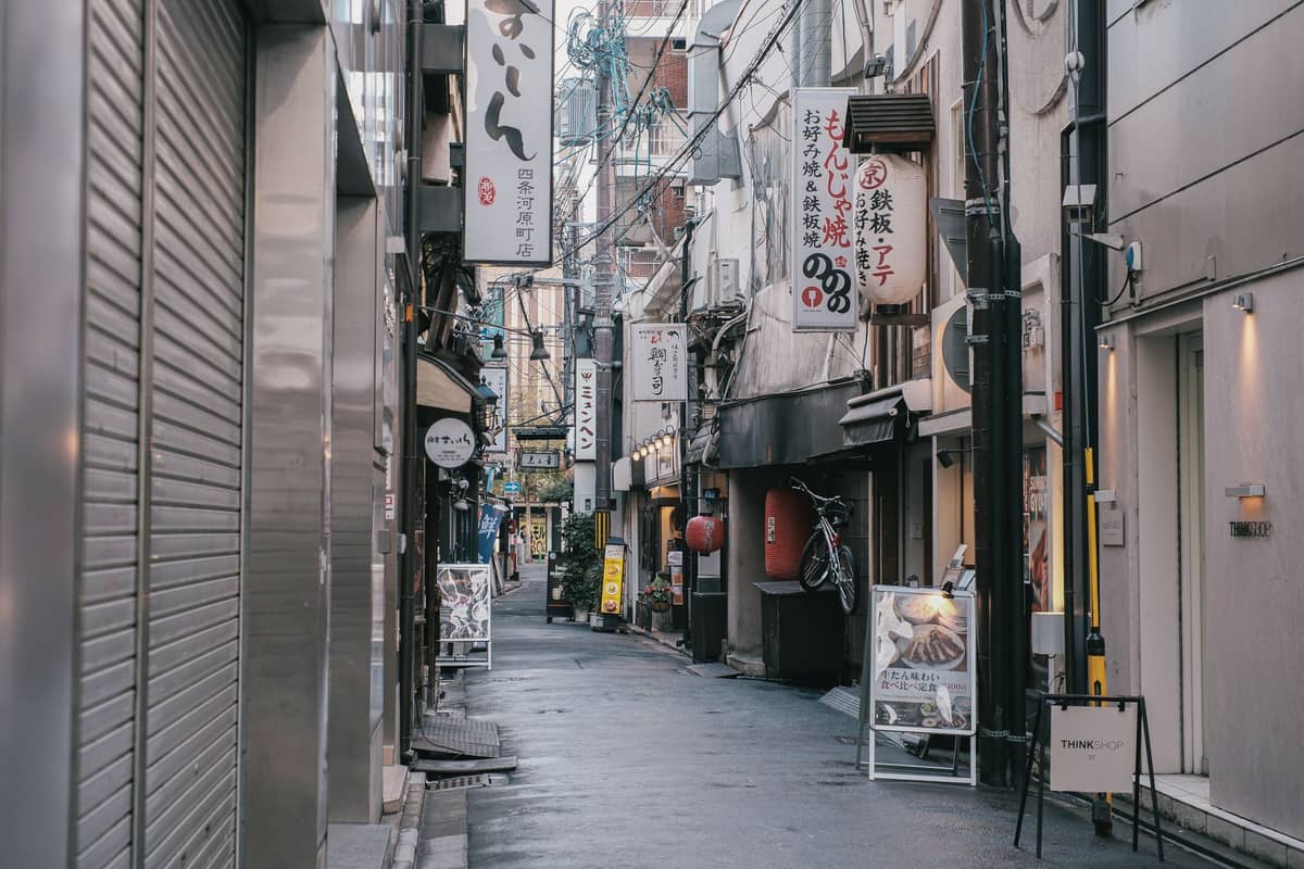 A narrow atmospheric alley lined with izakaya bars and restaurants in Kichijoji, Tokyo, with Japanese signs and a quiet, authentic local vibe.