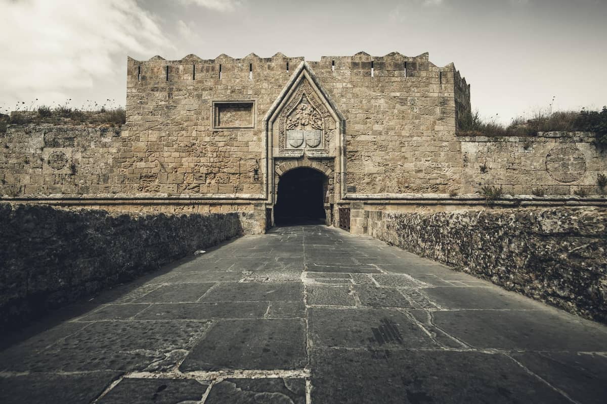 Stone medieval gate and fortified walls of Rhodes, viewed from the outside, showing the defensive entrance used during the Ottoman sieges.