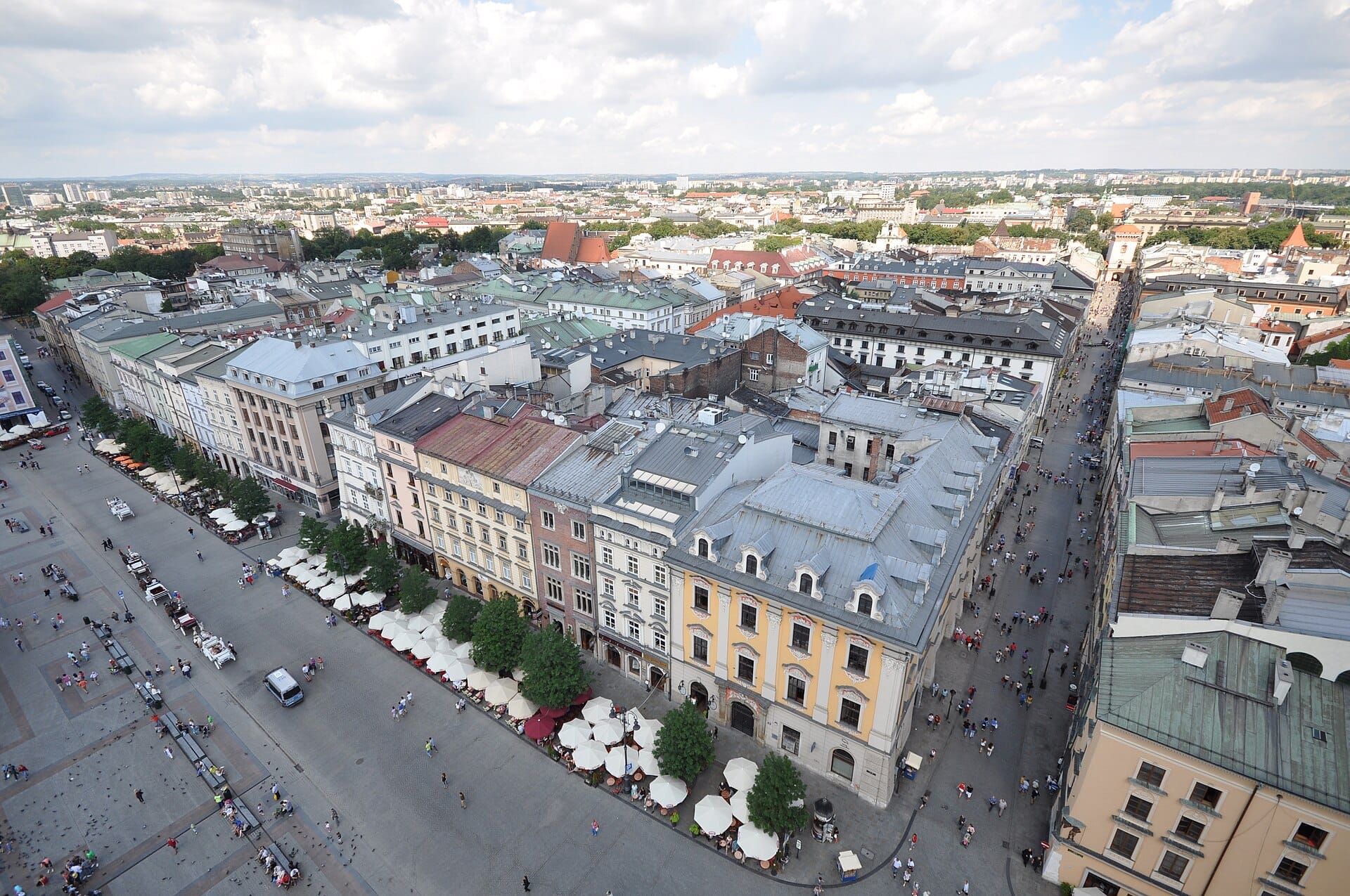 มุมมองทางอากาศของเมืองเก่า Kraków ที่แสดงให้เห็นผังถนนในยุคกลาง อาคารประวัติศาสตร์ และพื้นที่คนเดินเท้าที่คึกคักใกล้กับ Main Market Square