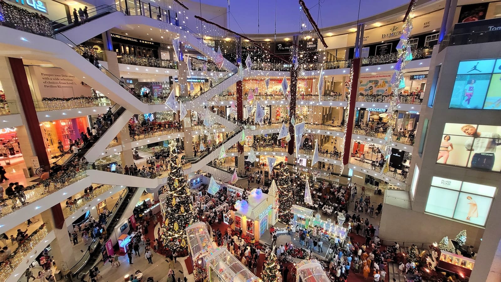 Vibrant interior of Pavilion Kuala Lumpur mall with luxury shops and bustling crowds in Bukit Bintang.