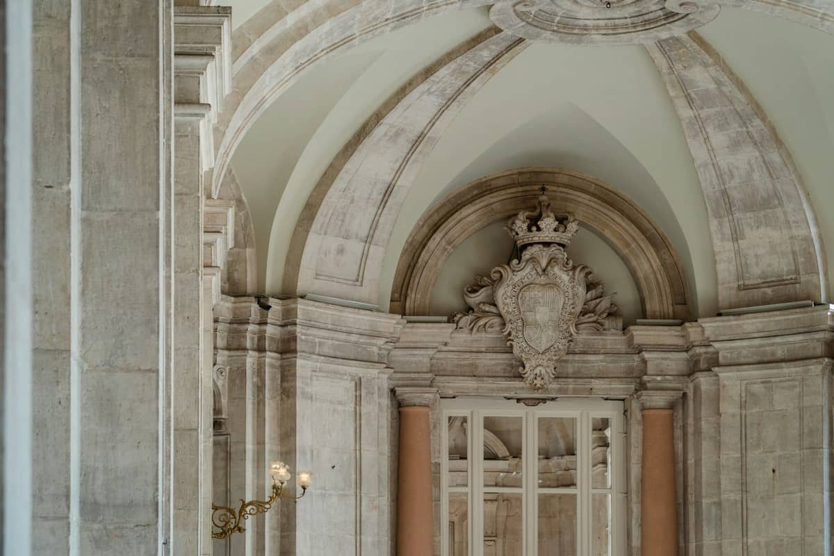 Elegant neoclassical interior with arched ceiling and ornate stone details, resembling the refined look of Madrid's secondary museums.