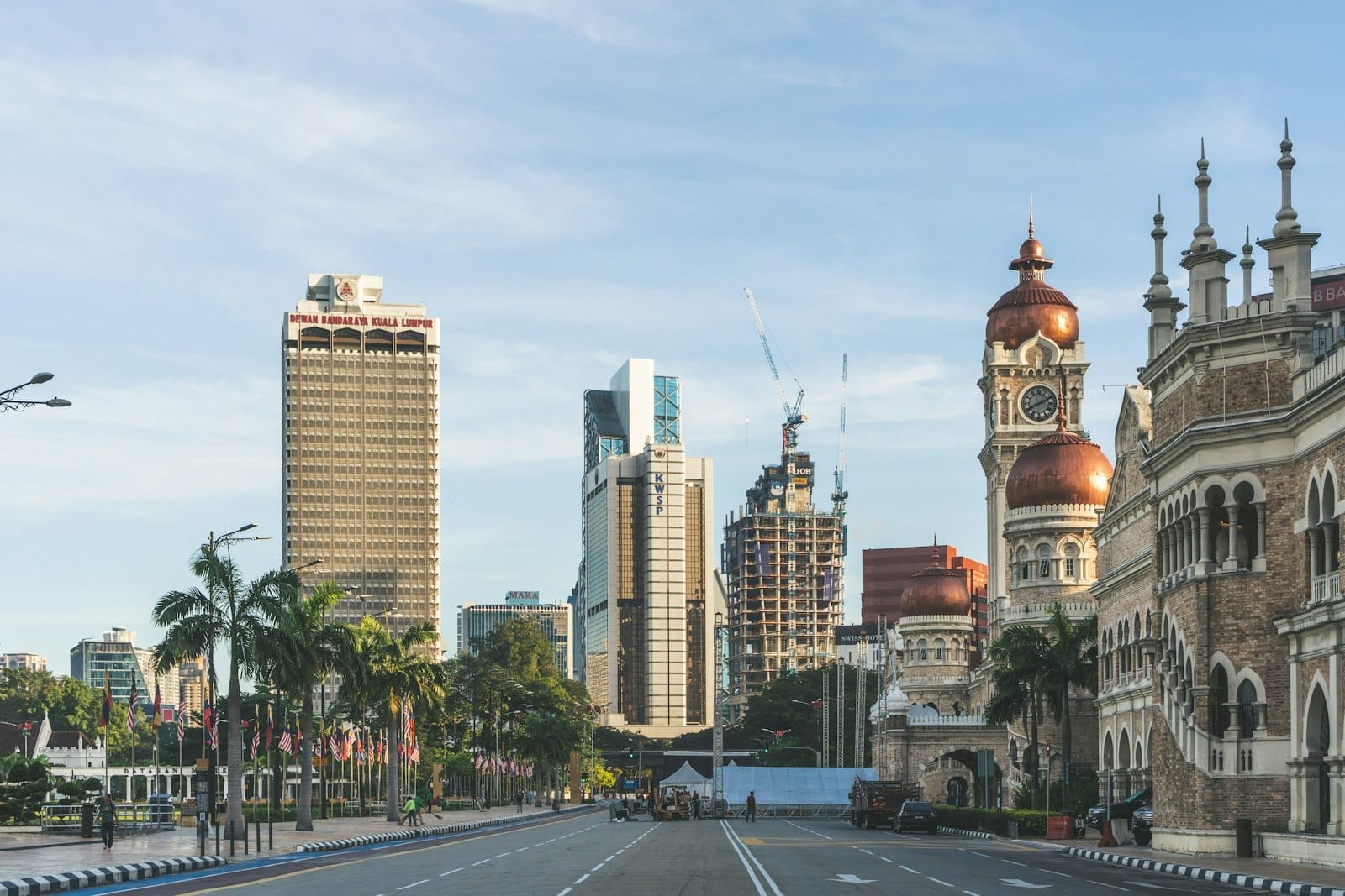 Sweeping view of Merdeka Square in Kuala Lumpur, featuring the iconic Sultan Abdul Samad Building and expansive green lawns.