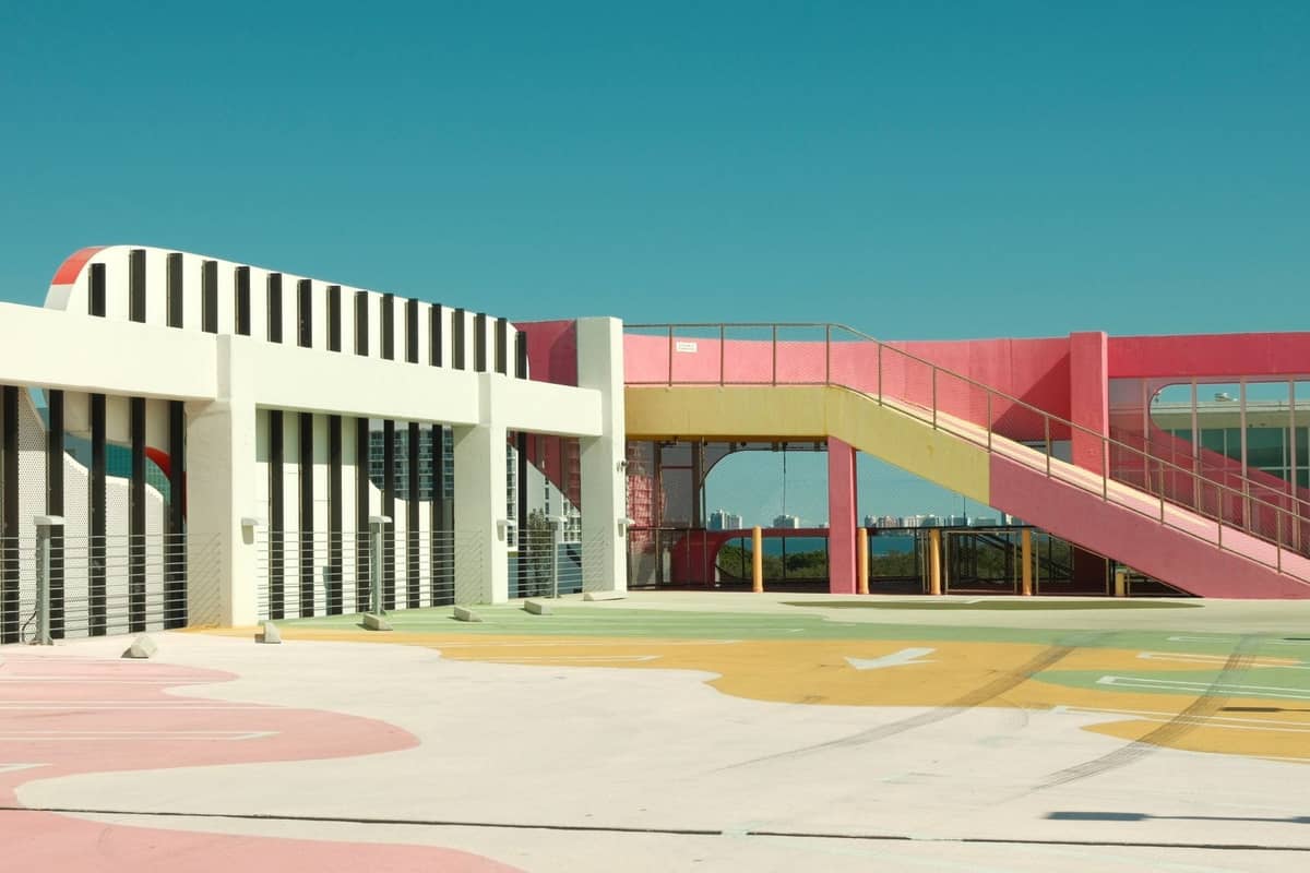 Colorful and artistic exterior of Miami's Museum Garage, with playful shapes and stripes under a clear sky.