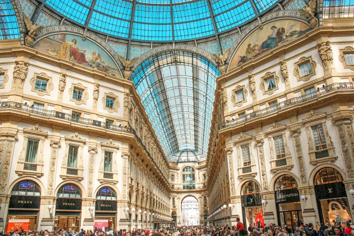 Vista interna della Galleria Vittorio Emanuele II a Milano, con la sua grande cupola in vetro e ferro sopra le ornate facciate storiche dei negozi.