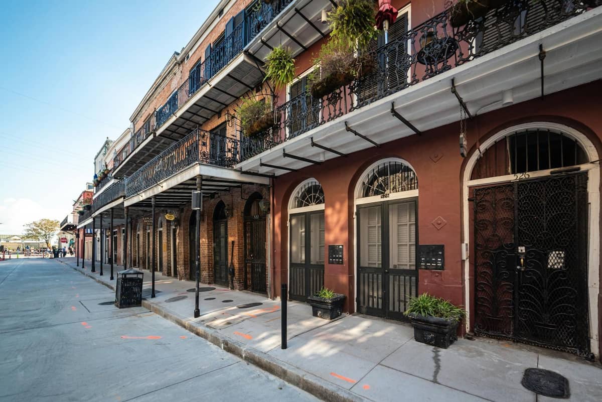 A classic New Orleans French Quarter street with iconic wrought iron balconies and no crowds early in the day.