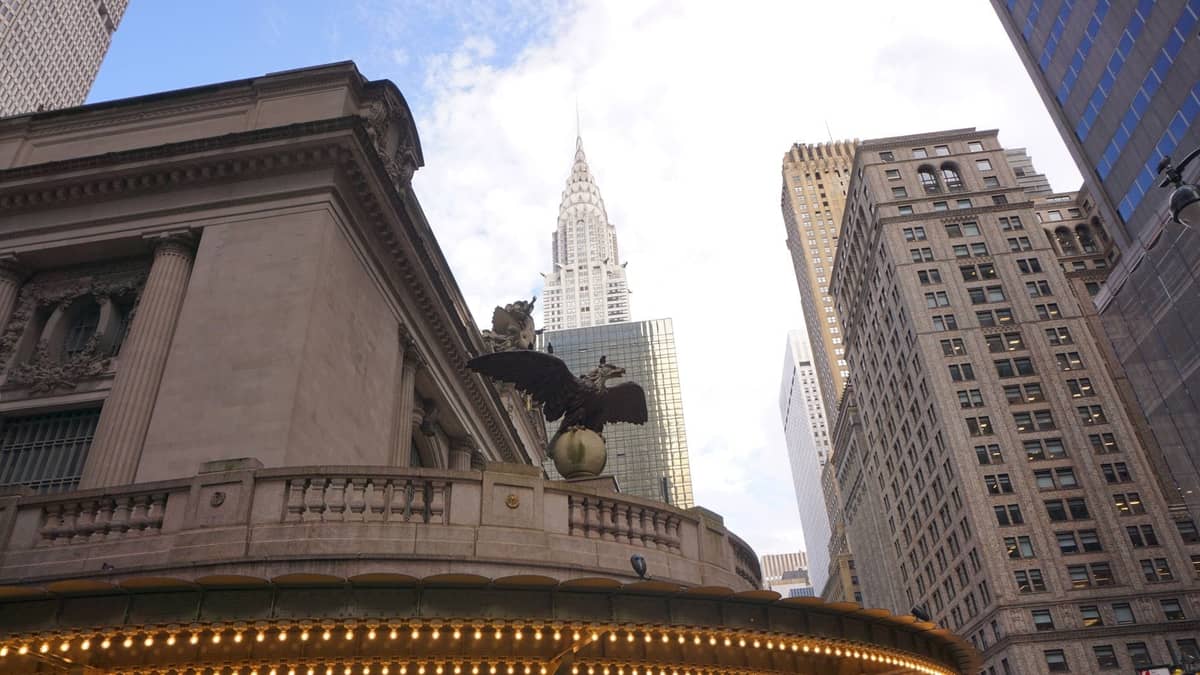 วิวของ Grand Central Terminal พร้อมรูปปั้นนกอินทรีในเบื้องหน้า และ Chrysler Building ที่สูงตระหง่านท่ามกลางตึกระฟ้าของ Midtown ใต้ท้องฟ้าสดใส