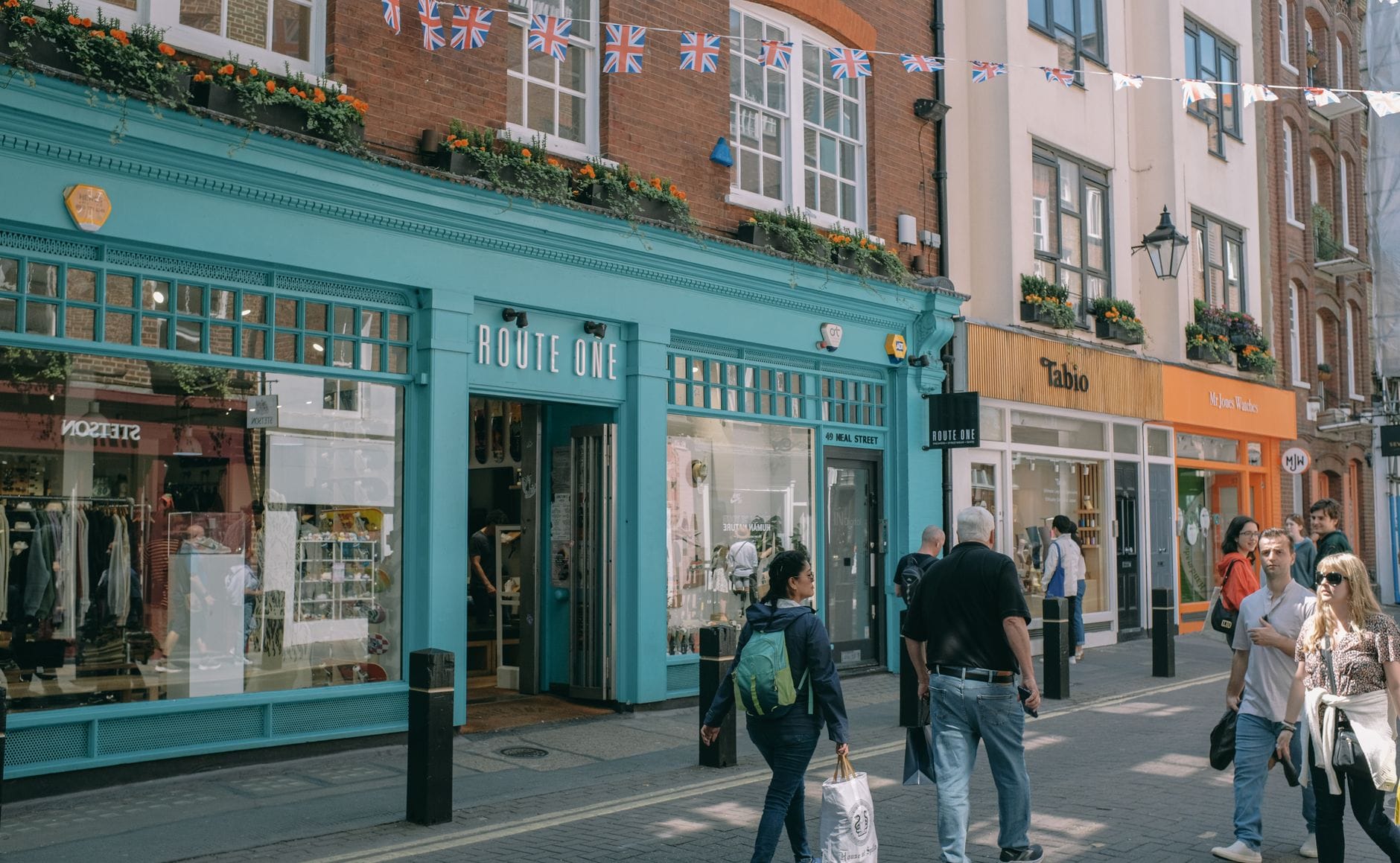 Pedestrian street in North Laine, Brighton, lined with colorful independent shops and people walking, capturing the area's vibrant urban atmosphere.