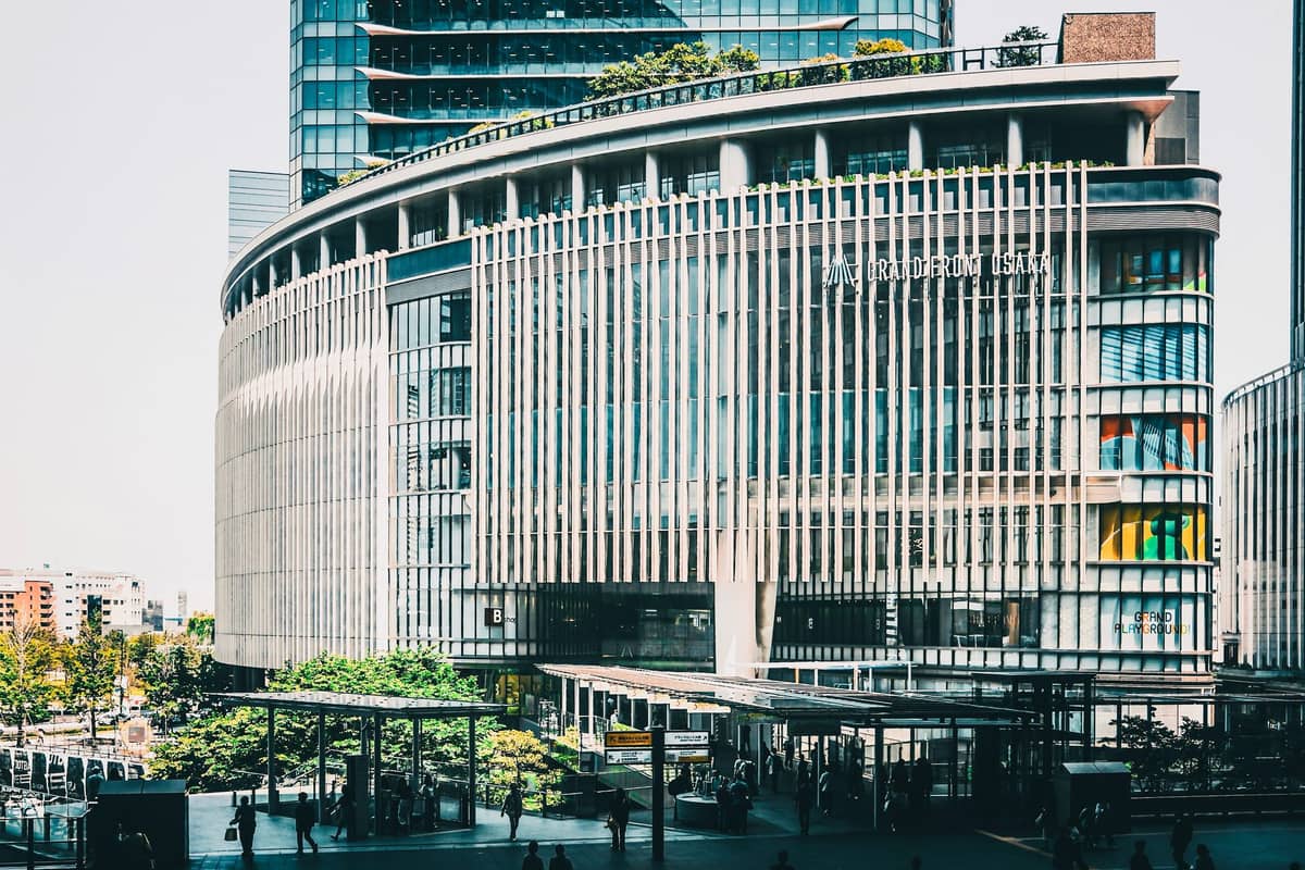 Daytime view of the Grand Front Osaka shopping and office complex in Umeda, with people outside and modern architecture prominent.