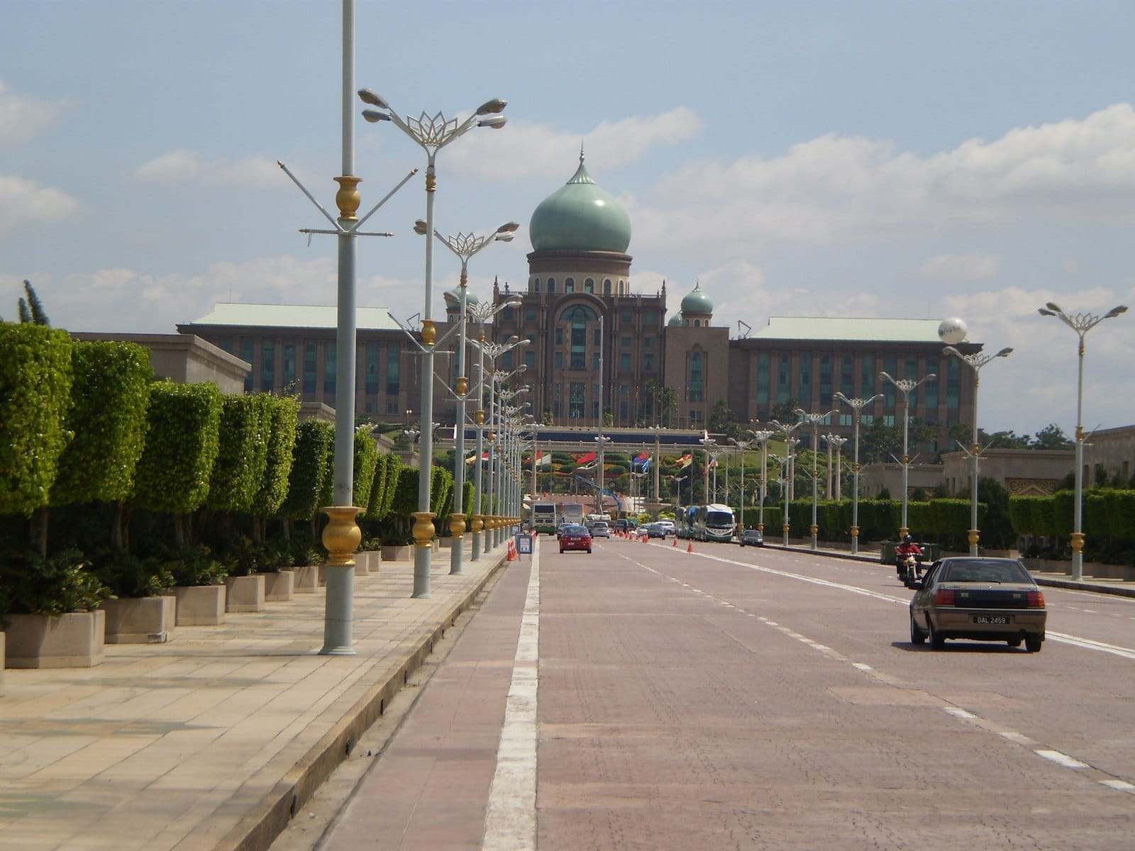 Majestic Perdana Putra with its iconic green dome rising above Putrajaya Lake, showcasing Moorish and Islamic architectural details.