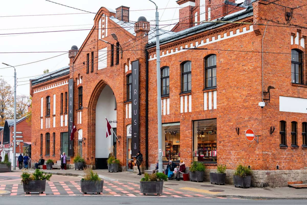 Außenansicht des Marktgebäudes im Kalnciema Quarter in Riga mit Menschen davor – ein zentraler Anlaufpunkt beim Shopping in Riga.