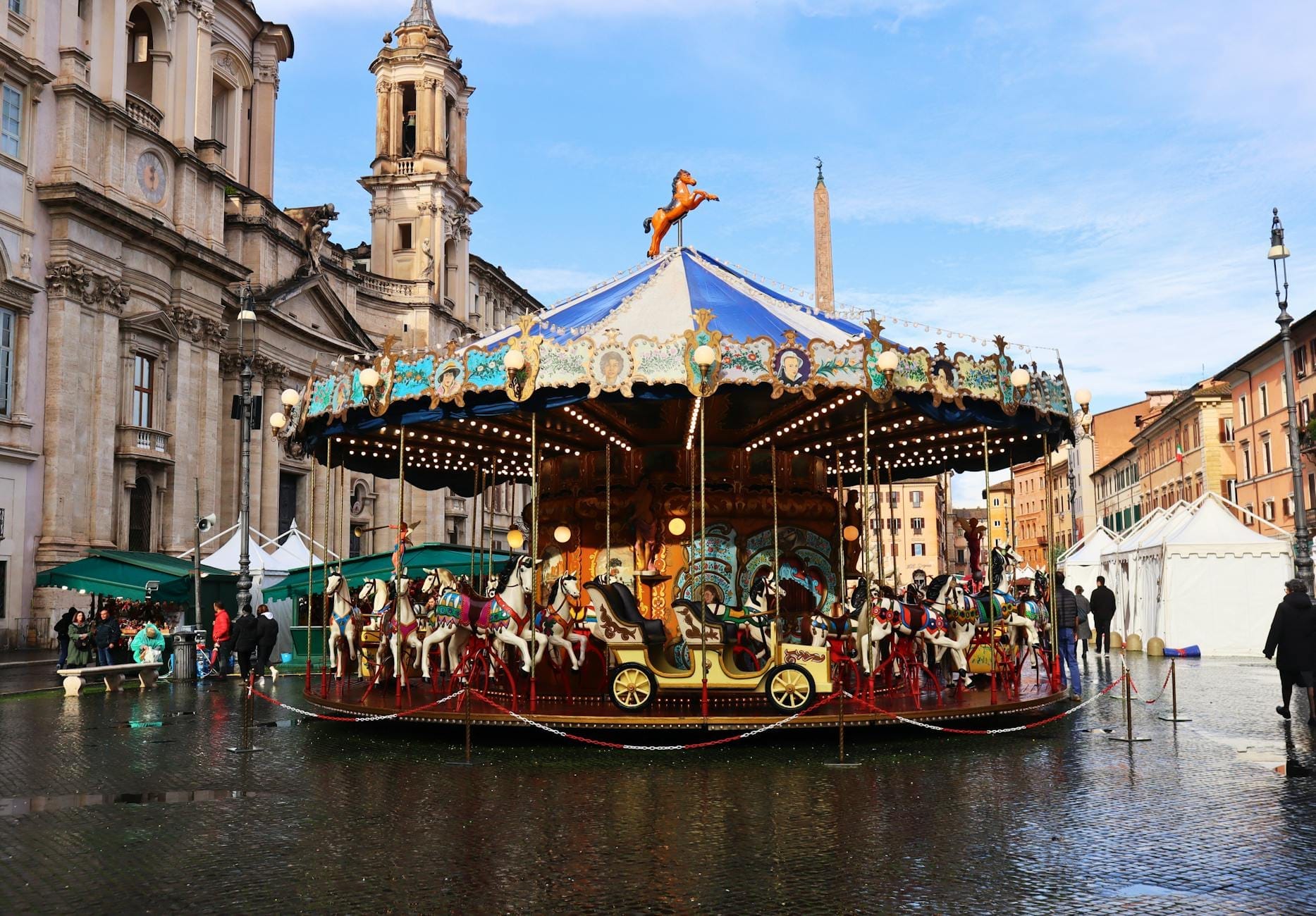 Colorful carousel with horses on Piazza Navona in Rome, surrounded by historic architecture and lively atmosphere, perfect for families visiting with children.