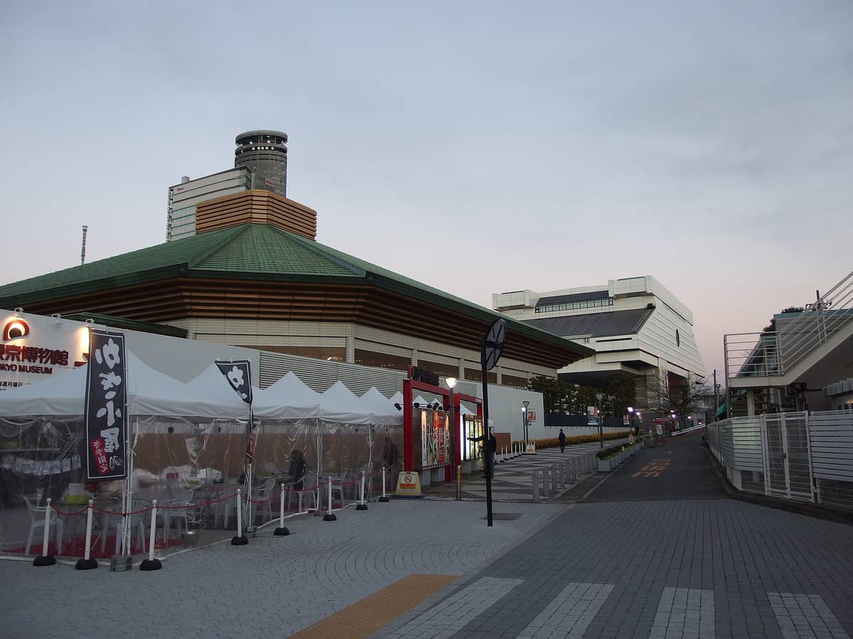Exterior view of the Ryogoku Kokugikan sumo stadium and Edo-Tokyo Museum at dusk in the Ryogoku district of Tokyo.
