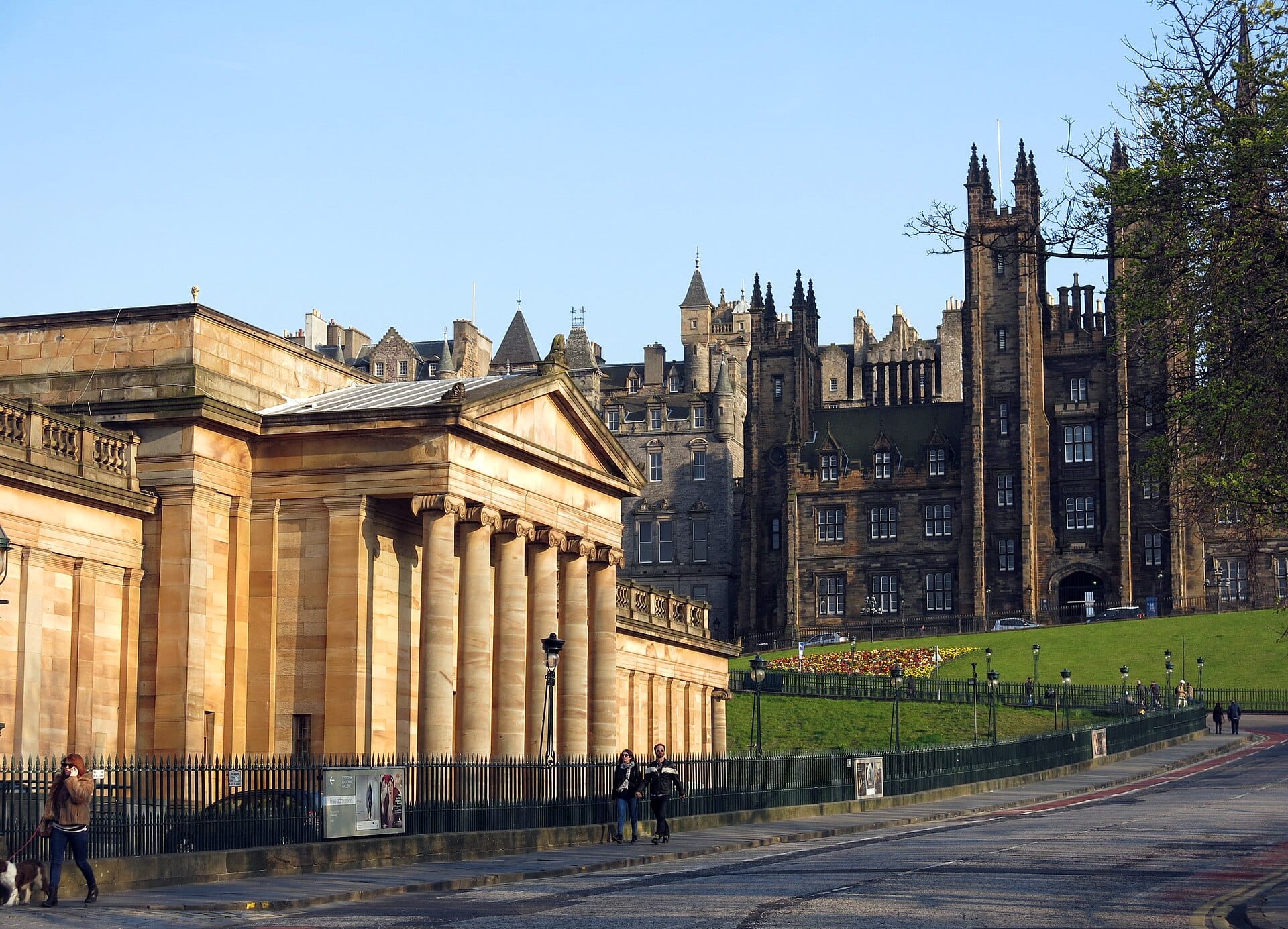 Die neoklassizistische Fassade der Scottish National Gallery mit imposanten Säulen und belebter Straße im Vordergrund, mitten in Edinburgh.