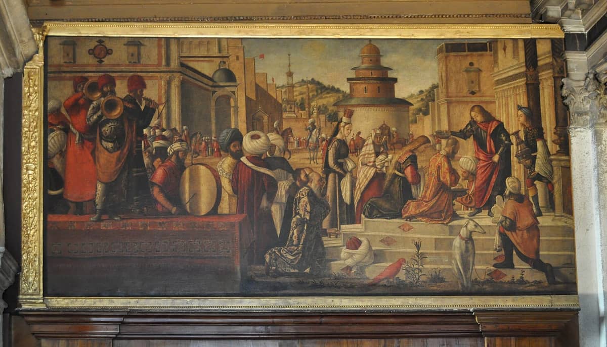 Gemälde von Vittore Carpaccio aus der Scuola Dalmata dei Santi Giorgio e Trifone, das eine aufwendige Szene mit Figuren in Turbanen, Musikern und reich gekleideten Menschen zeigt.