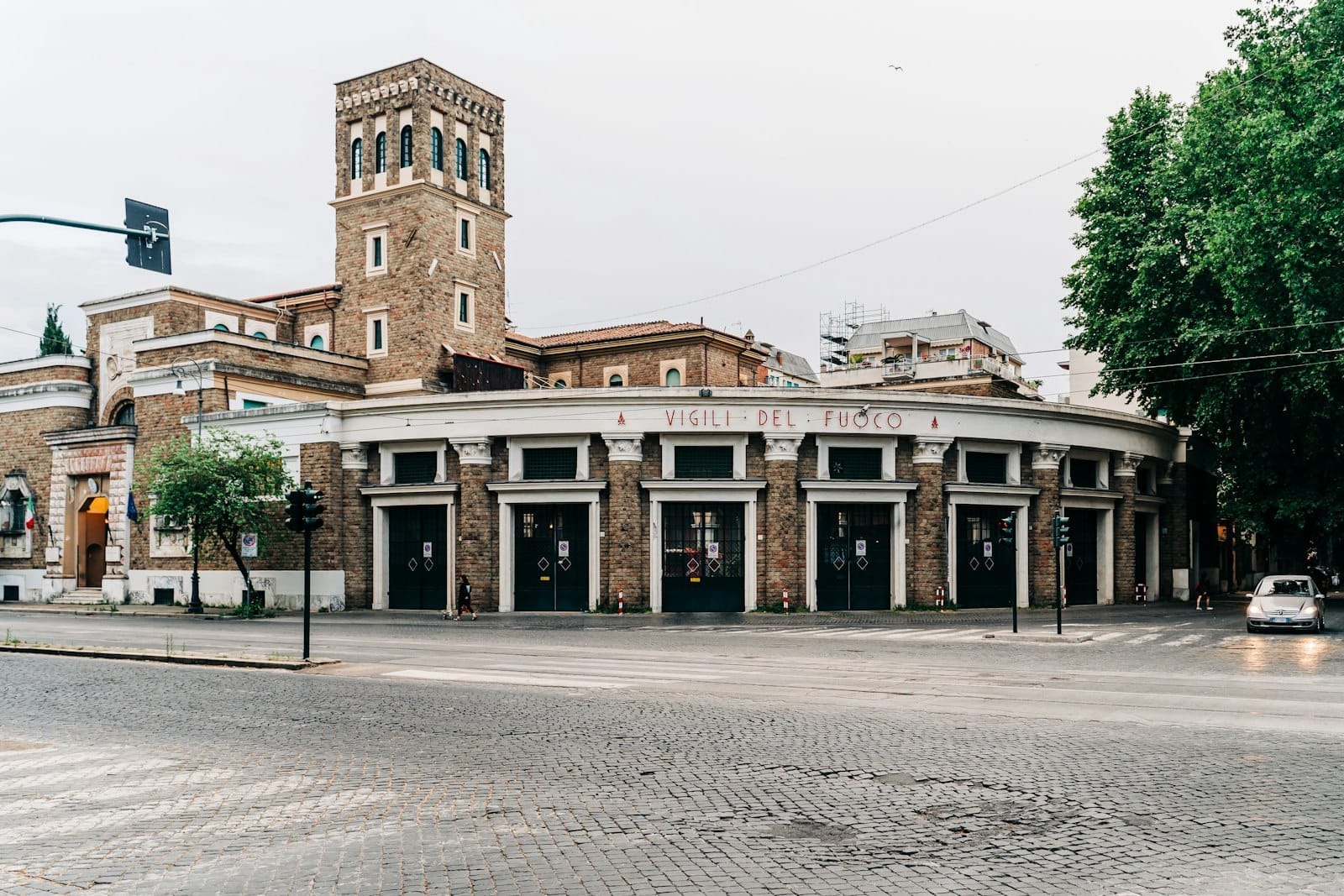 Historic brick building with distinctive round façade and tower in Testaccio, Rome, showcasing the area's everyday Roman character and architectural heritage.