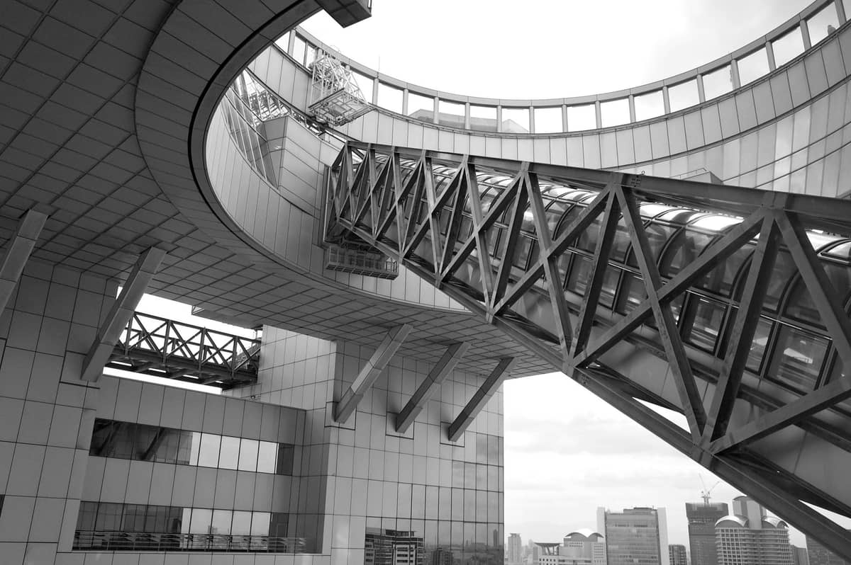 Close-up view of the Umeda Sky Building's distinctive sky bridge and circular observation structure with Osaka's skyline in the background.