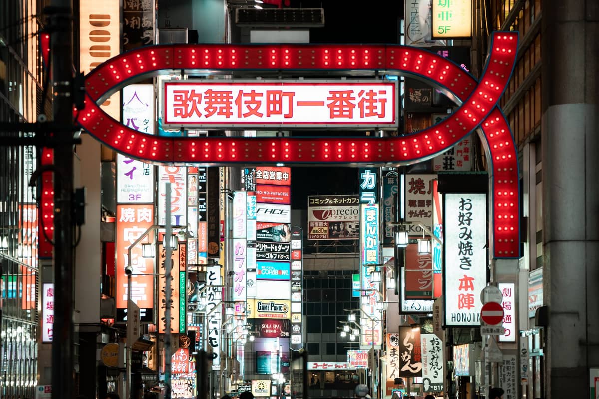 Night view of Kabukicho Ichibangai gate and neon-lit buildings in Shinjuku, Tokyo’s most famous nightlife and entertainment district.
