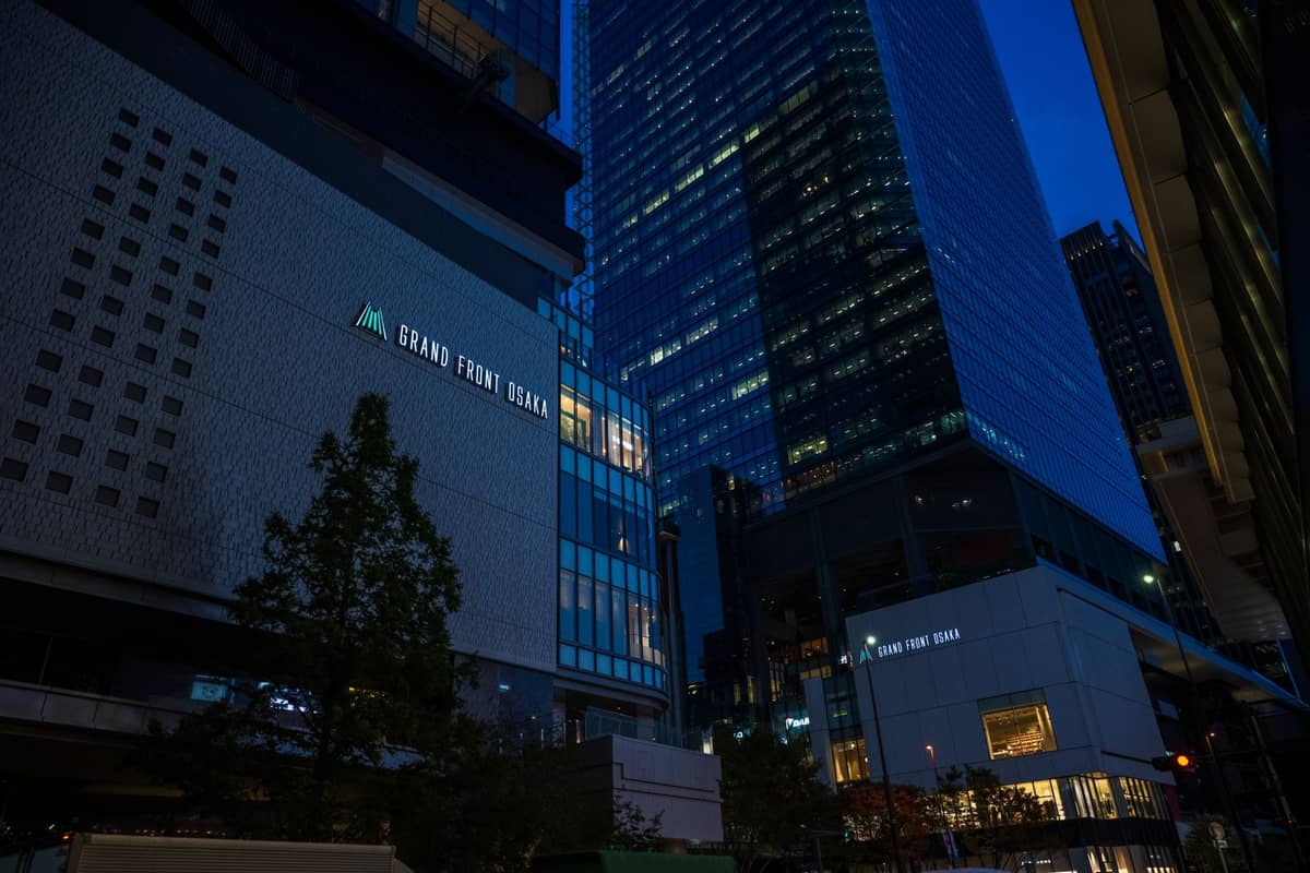 Nighttime view of Grand Front Osaka and towering high-rise office buildings in the Umeda district, the commercial hub of Osaka's Kita area.
